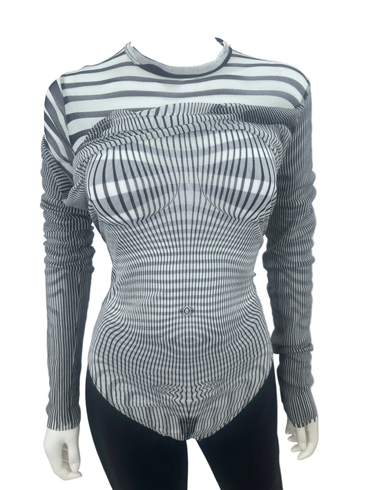 A long-sleeve ribbed knit top with a black and white wavy stripe pattern, displayed on a mannequin torso against a plain white wall.