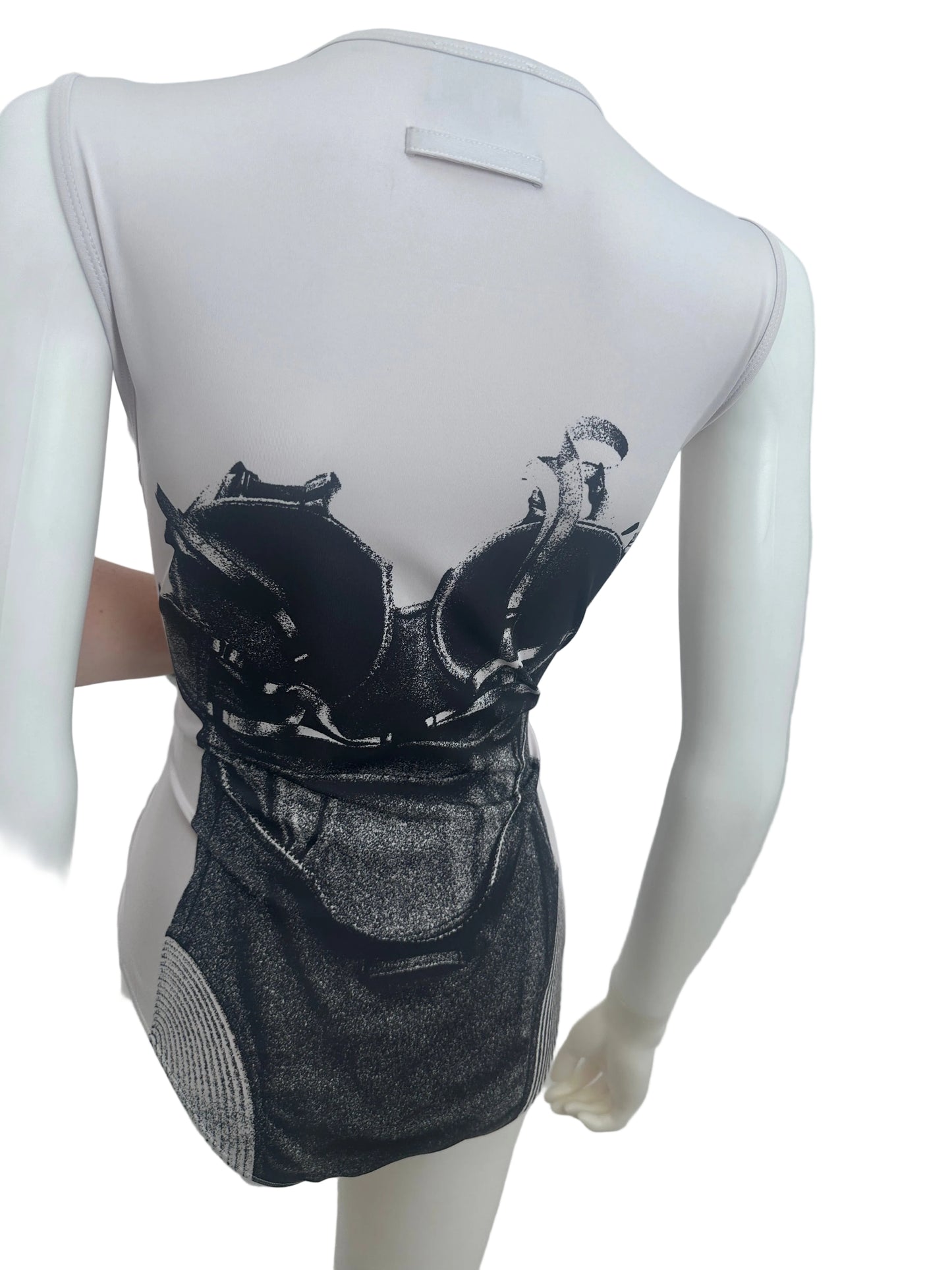 A white mannequin torso wearing a black and gray graphic print garment, photographed against a plain light background.