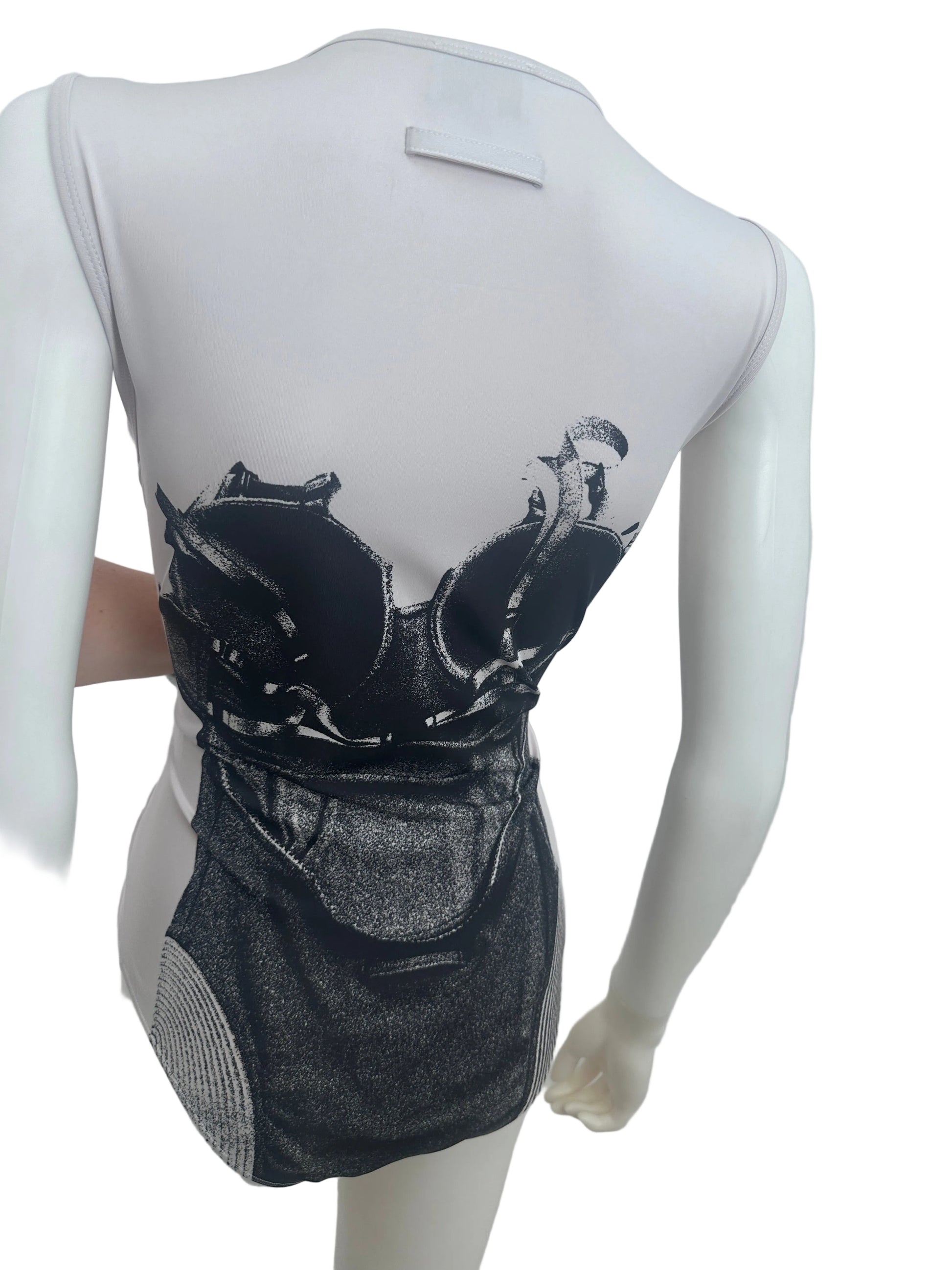 A white mannequin torso wearing a black and gray graphic print garment, photographed against a plain light background.