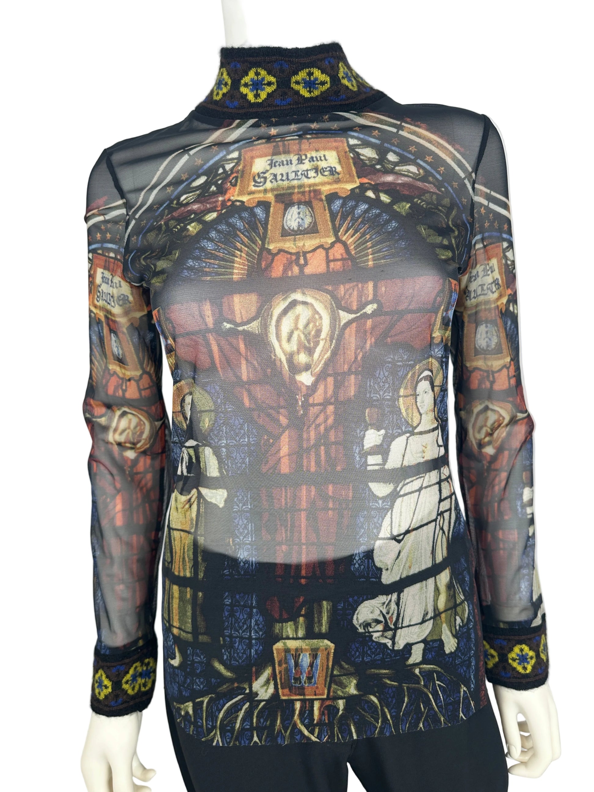 Mannequin wearing a patterned garment with religious iconography on a white background