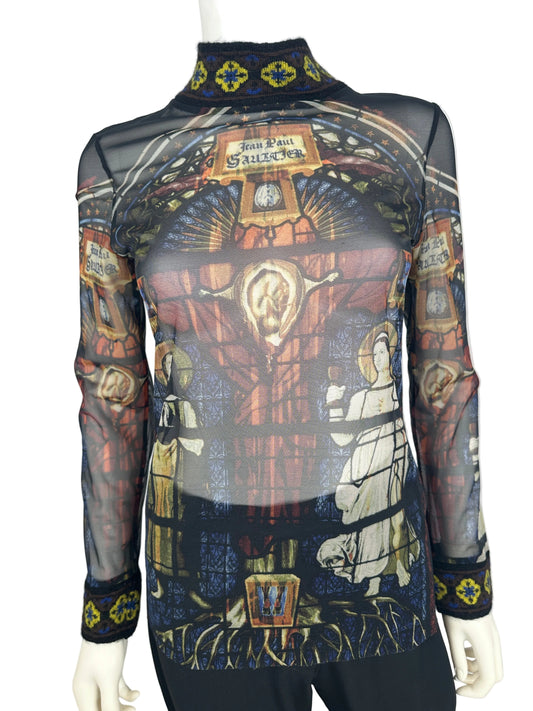 Mannequin wearing a patterned garment with religious iconography on a white background