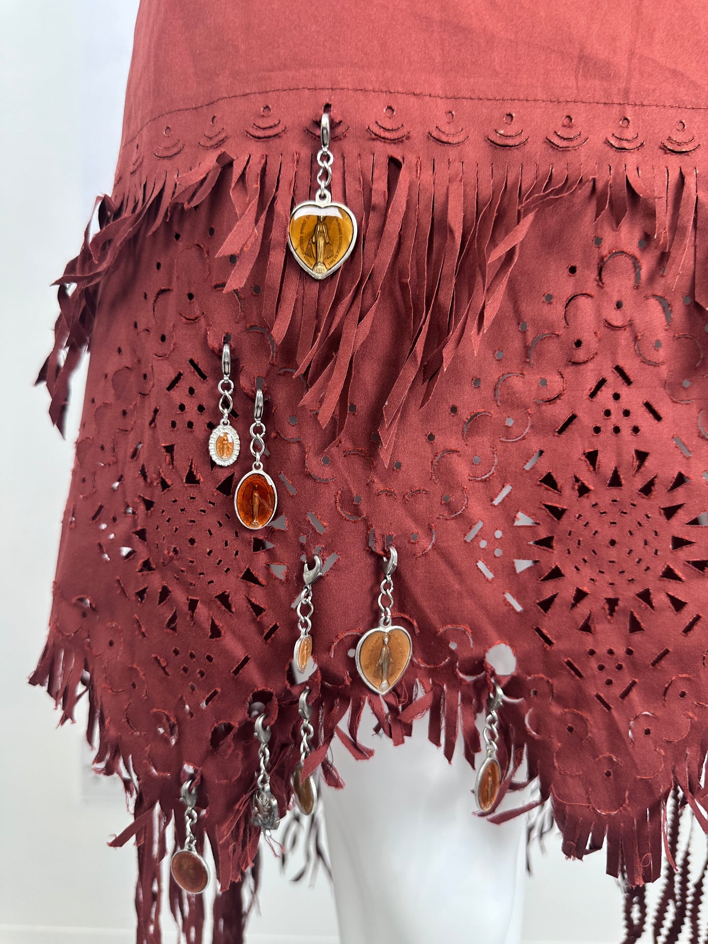Close Up of a red fringe skirt with charm details