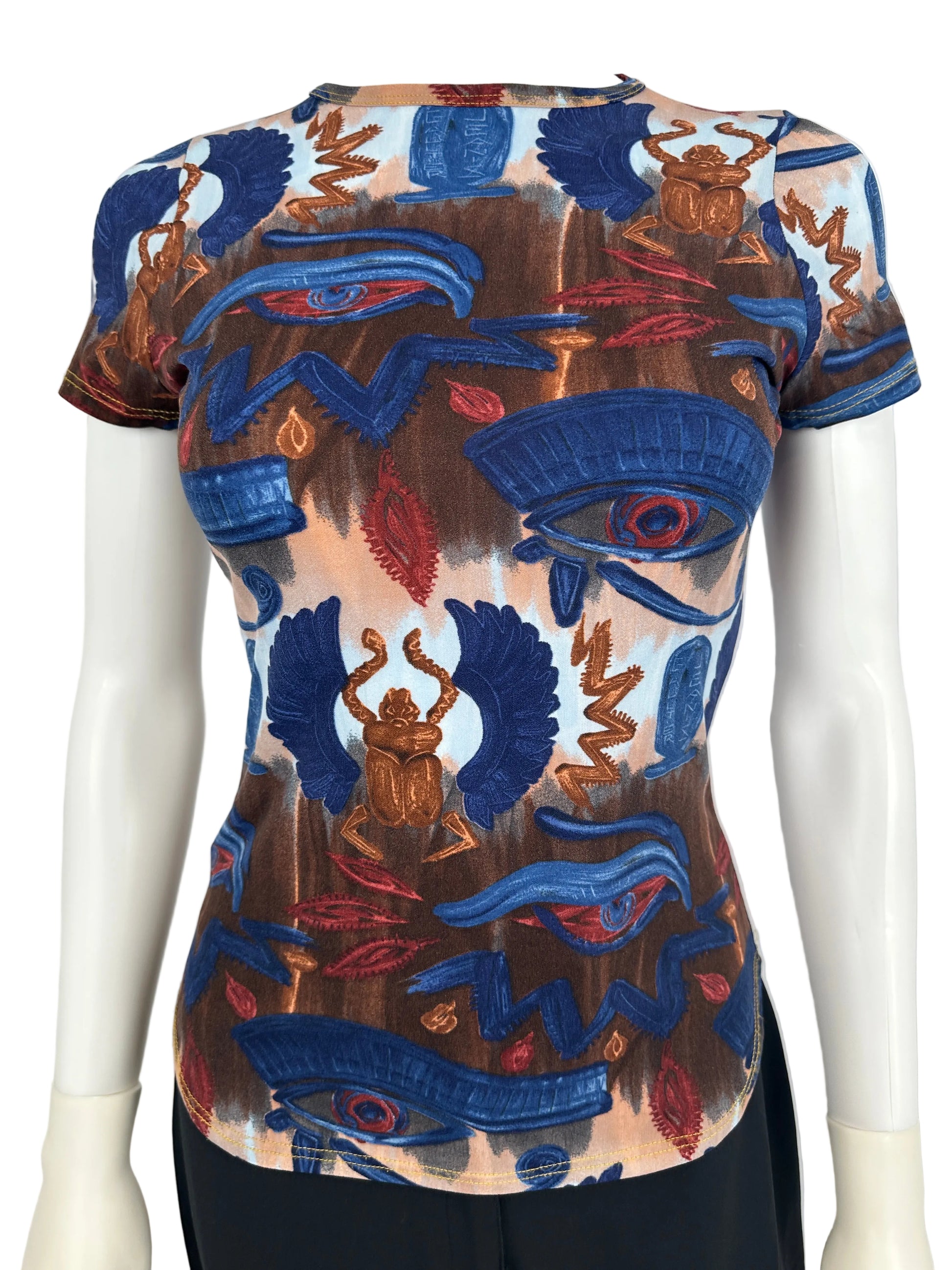 Colorful embroidered design on a mannequin against a neutral background