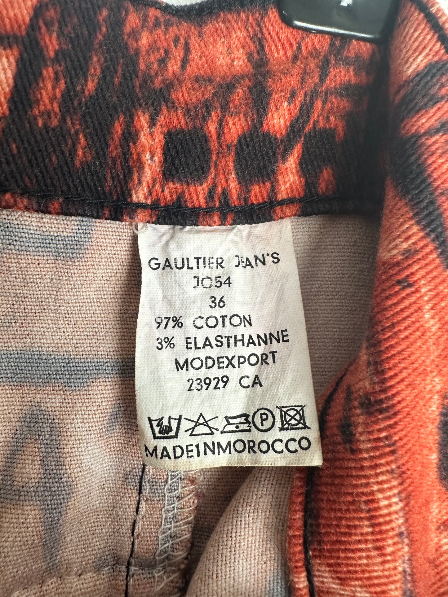 Fabric tag with text and a logo on a textured fabric background