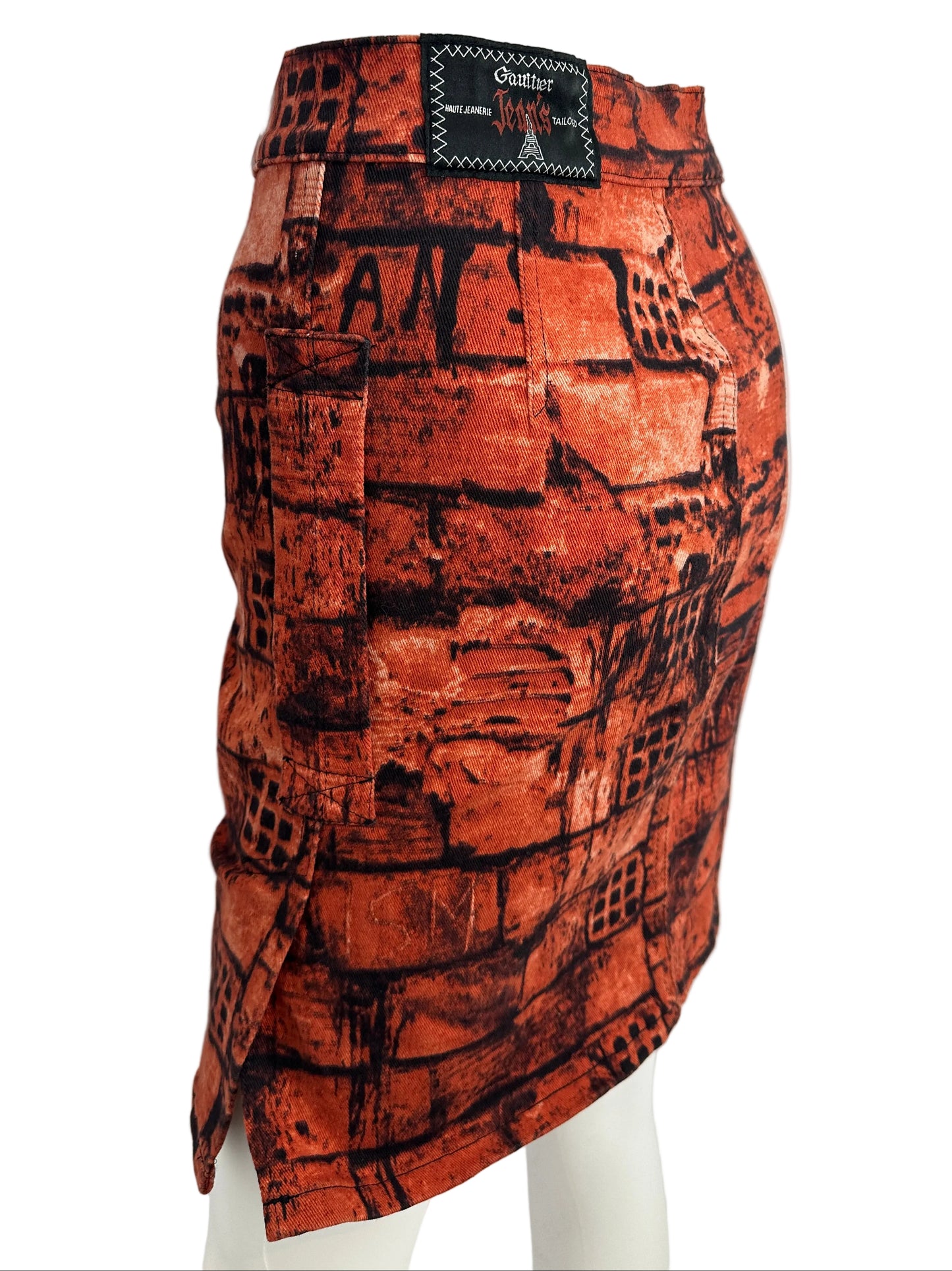 Reddish-brown patterned fabric on a white mannequin arm