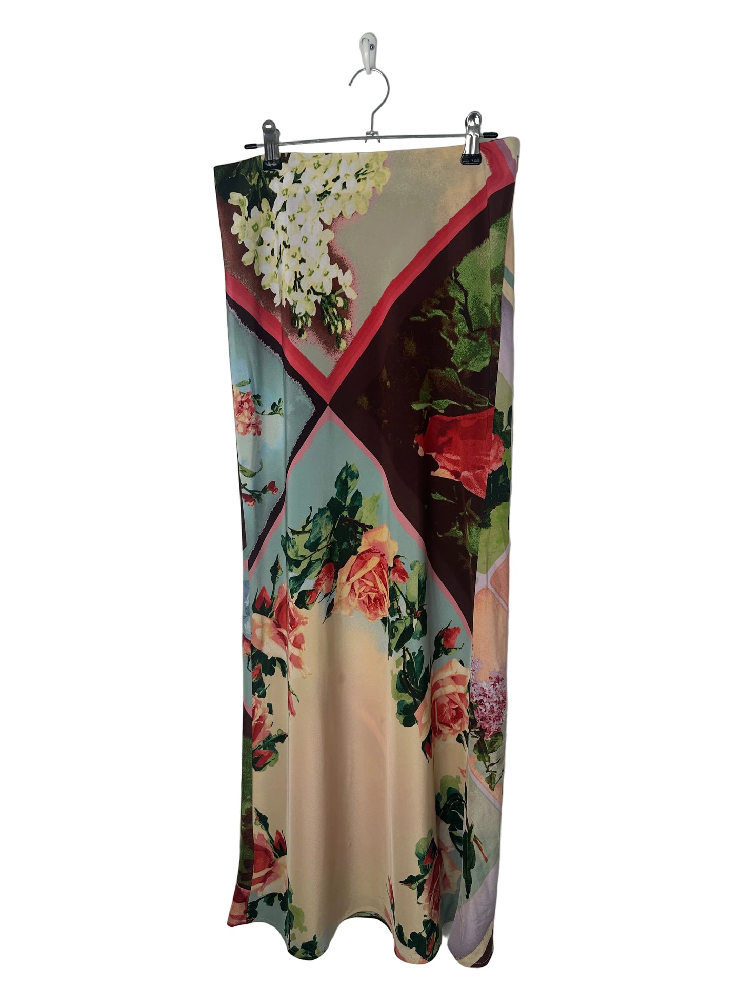Floral patterned fabric on a hanger against a white background