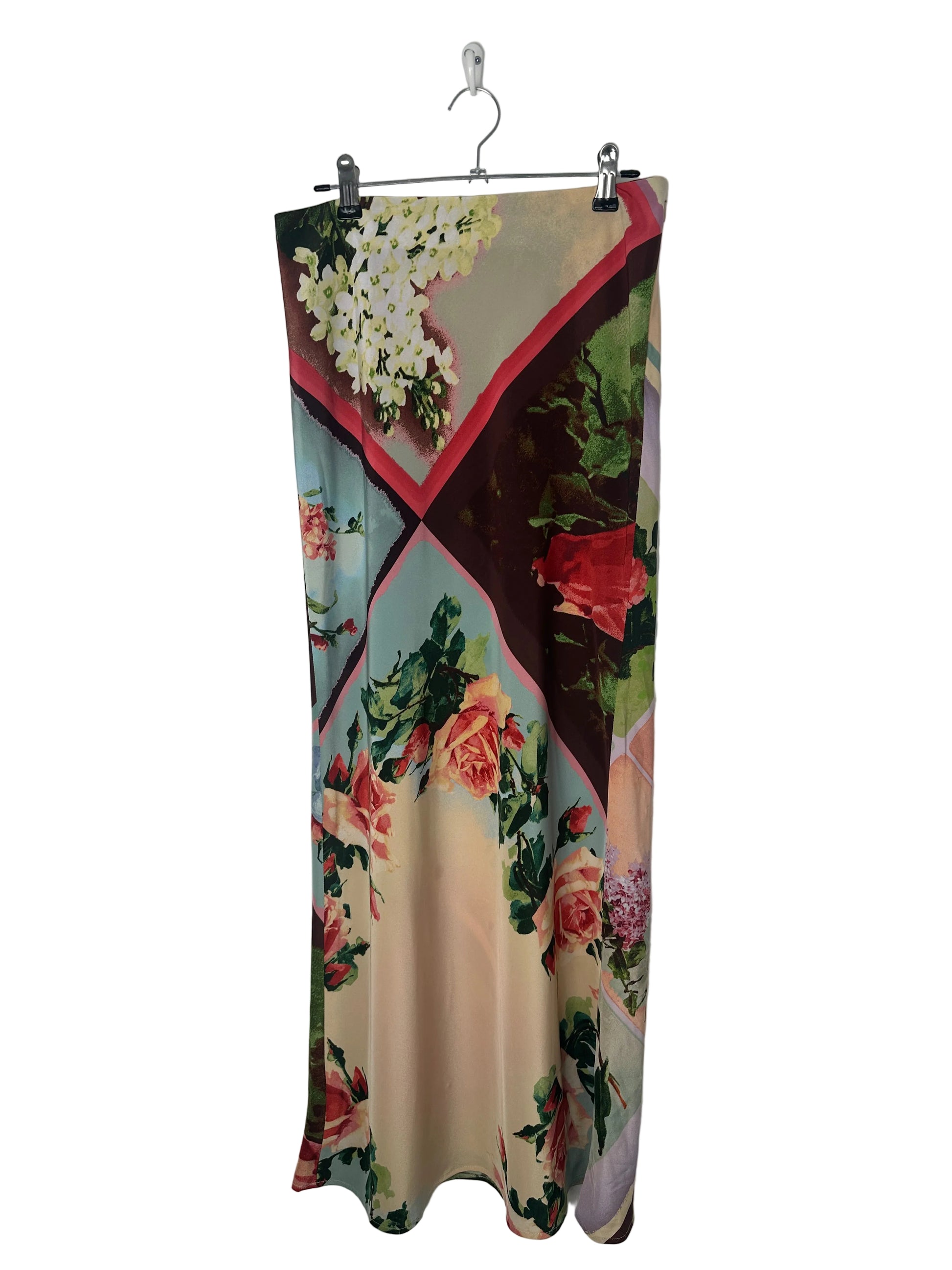 Floral patterned fabric on a hanger against a white background