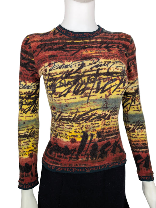 Colorful patterned sweater on a mannequin against a white background