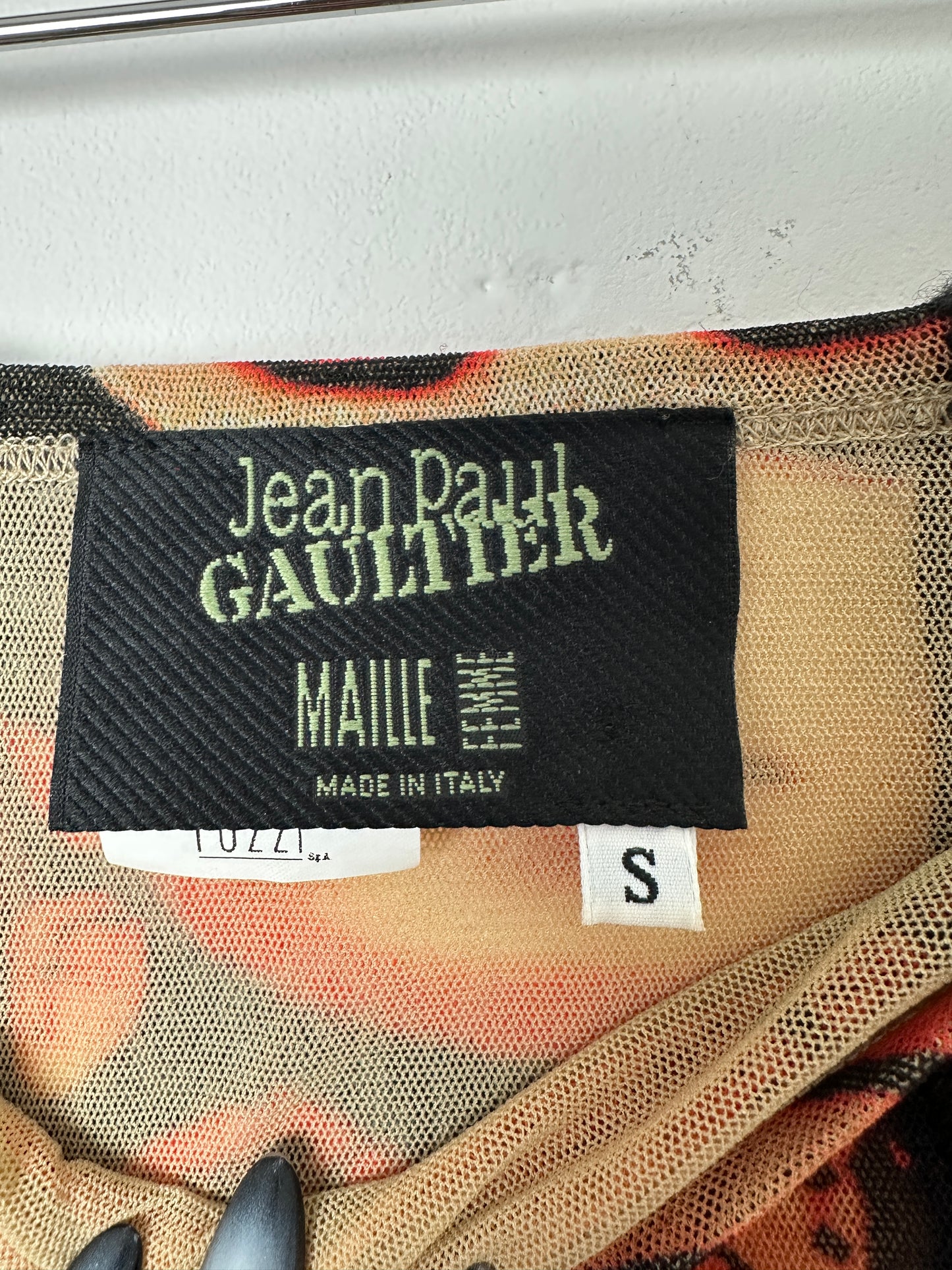 Close-up of a label on a garment with 'Jean Paul Gaultier' branding.