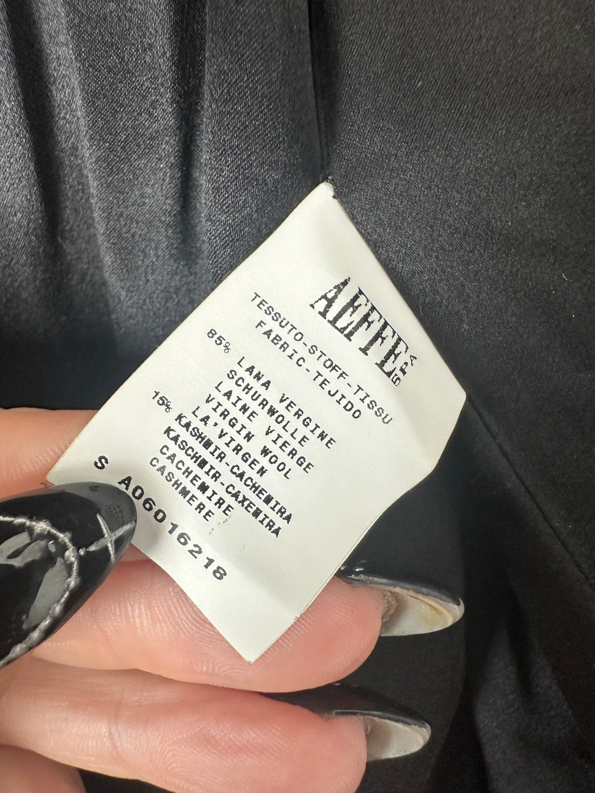 Fabric label on a garment held by a hand