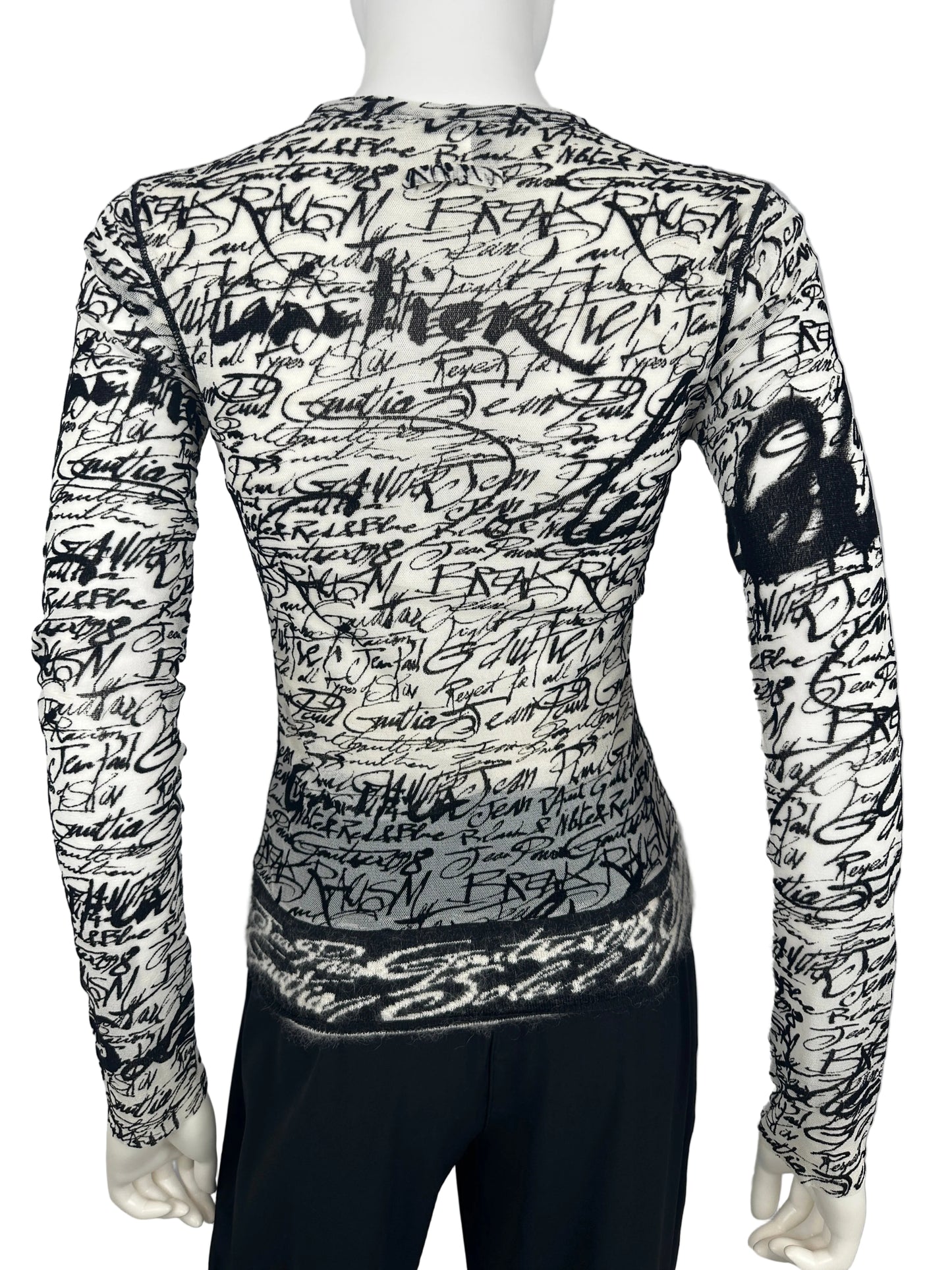 Black and white patterned garment on a mannequin against a gray background