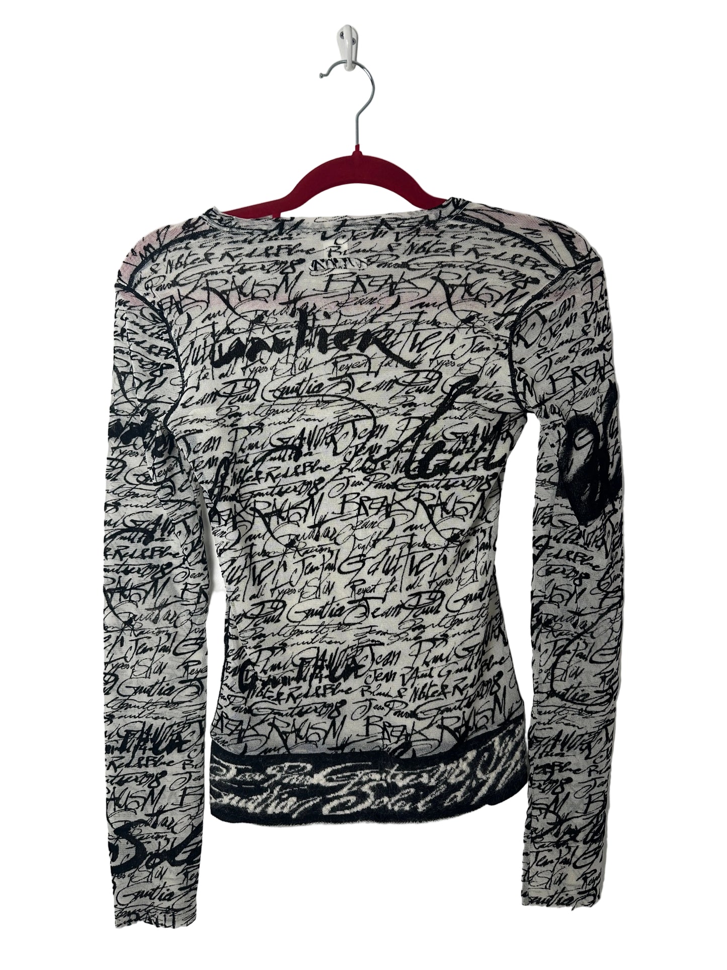 Black and white patterned shirt on a hanger against a white background