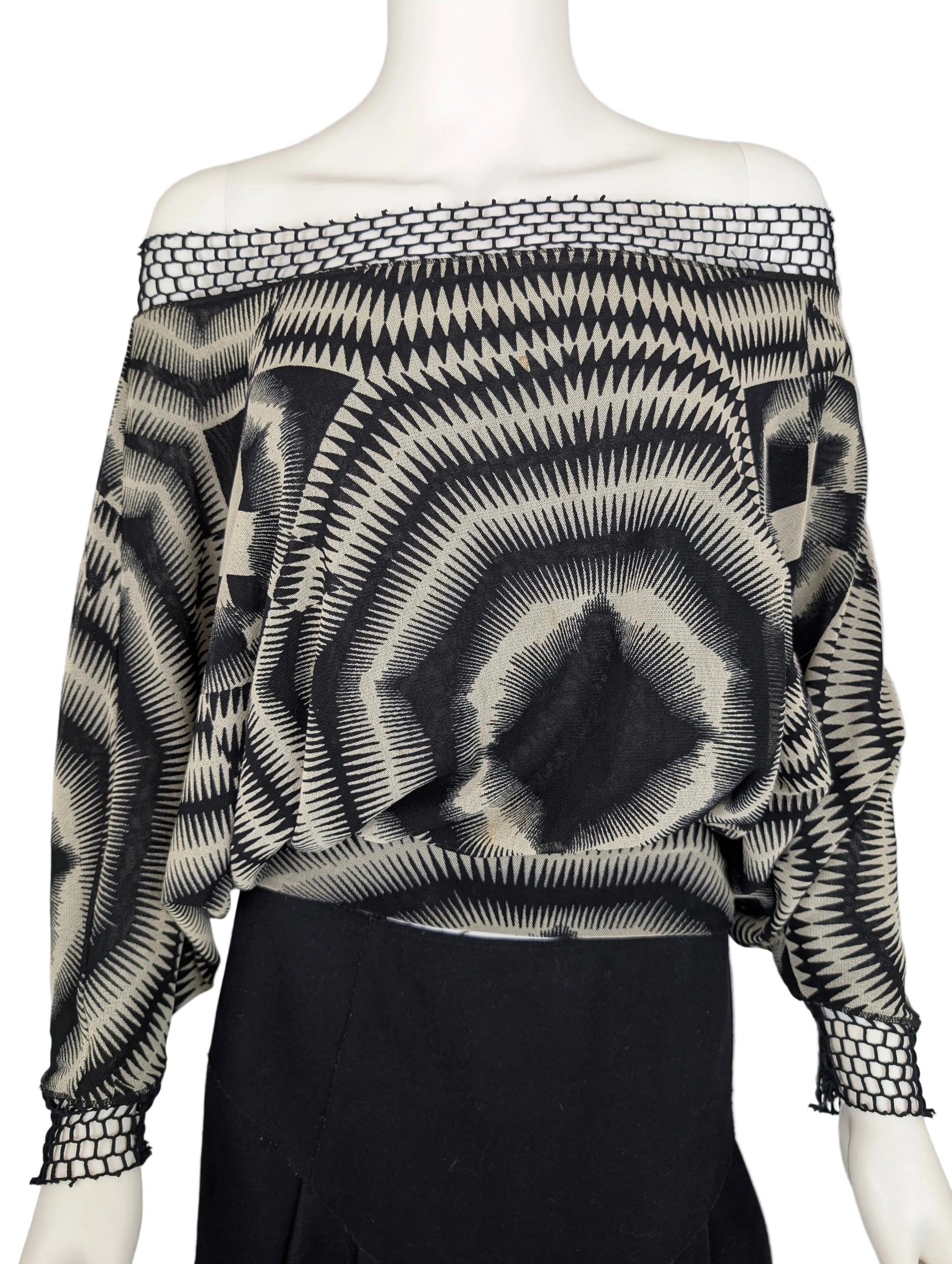 Black and white patterned off-shoulder top on a mannequin against a gray background