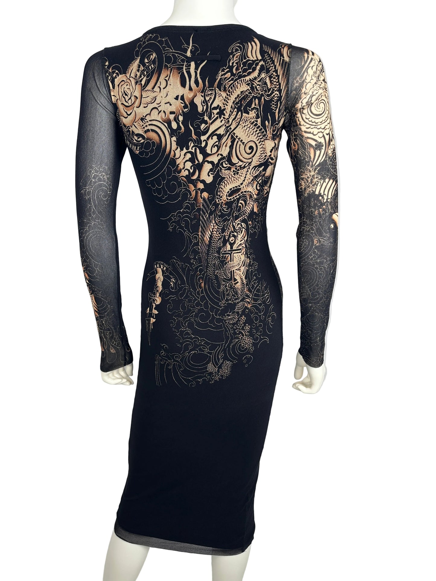 Black dress with gold intricate patterns on a white surface