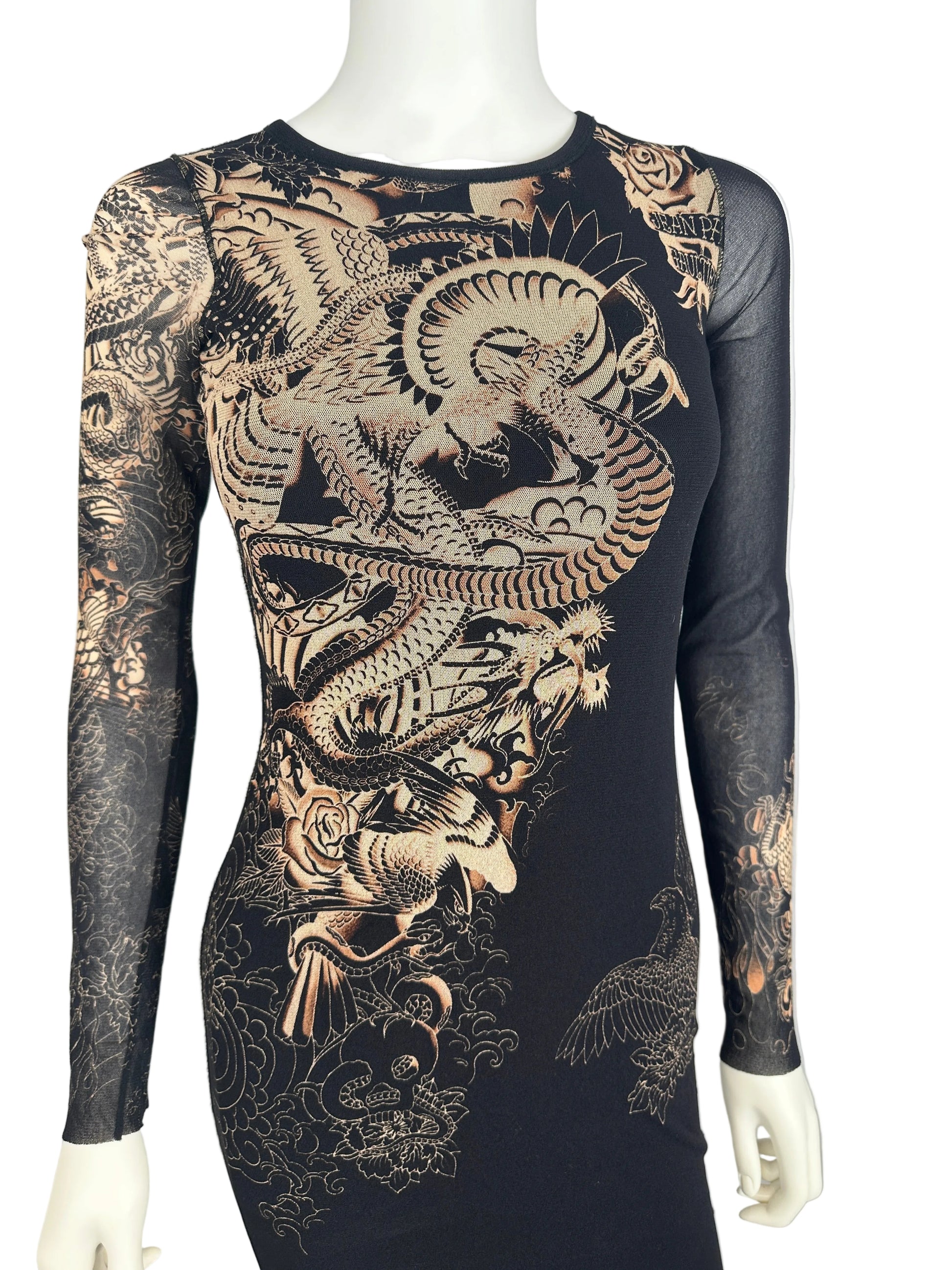 Black dress with intricate gold dragon design on a mannequin against a white background