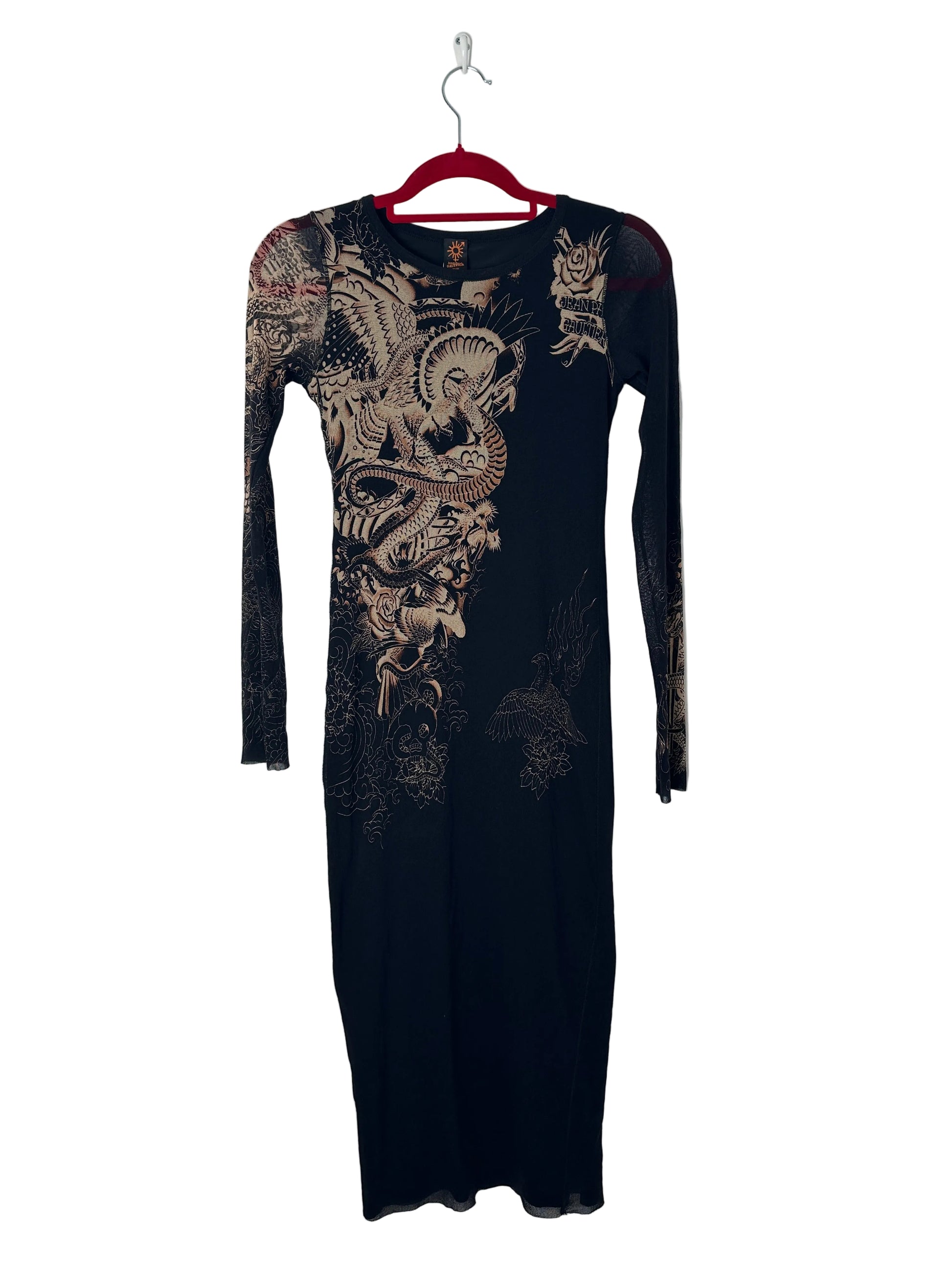 Black garment with intricate gold embroidery on a white background