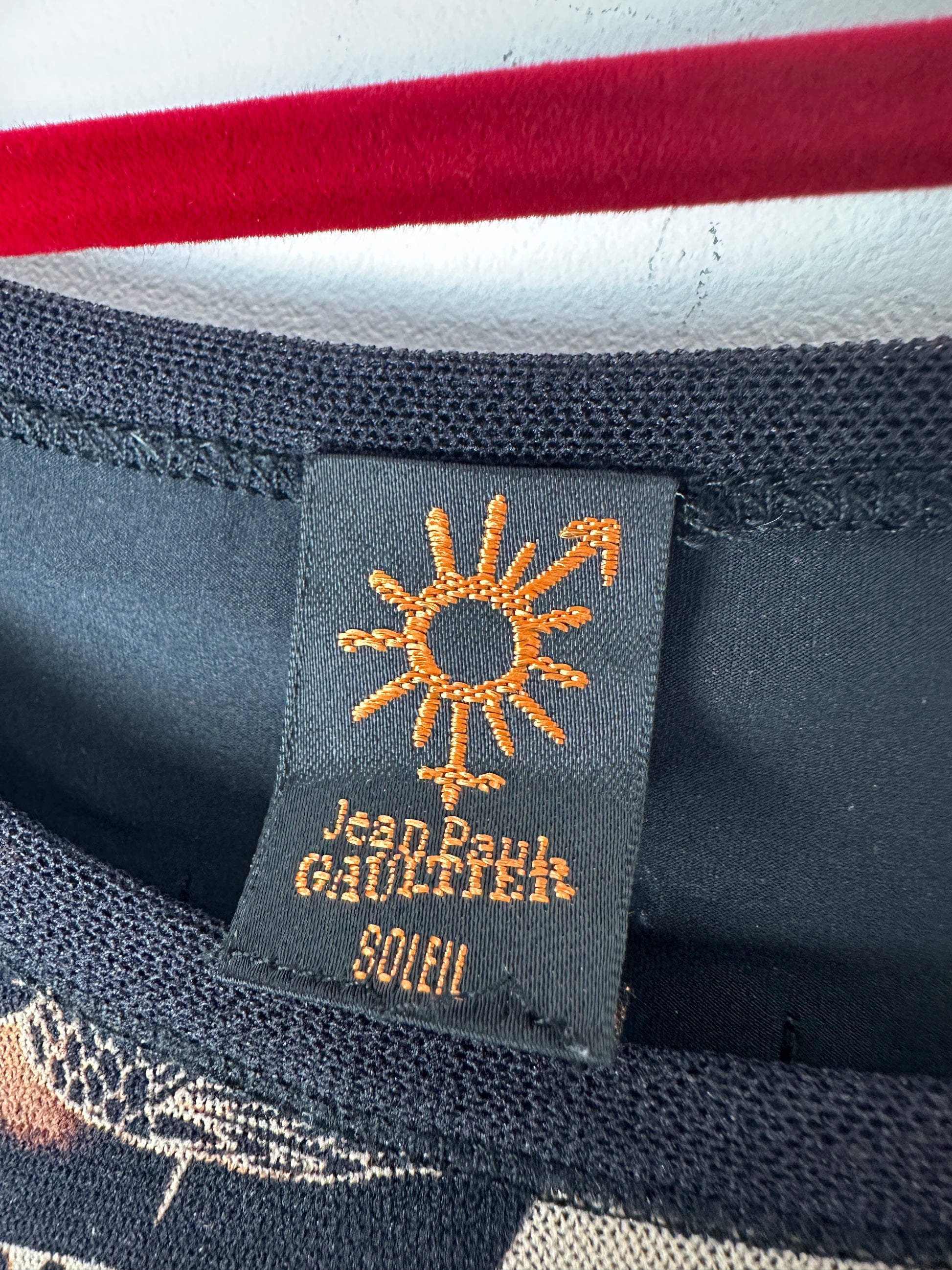 Close-up of a label with a sun design and text on a textured fabric background