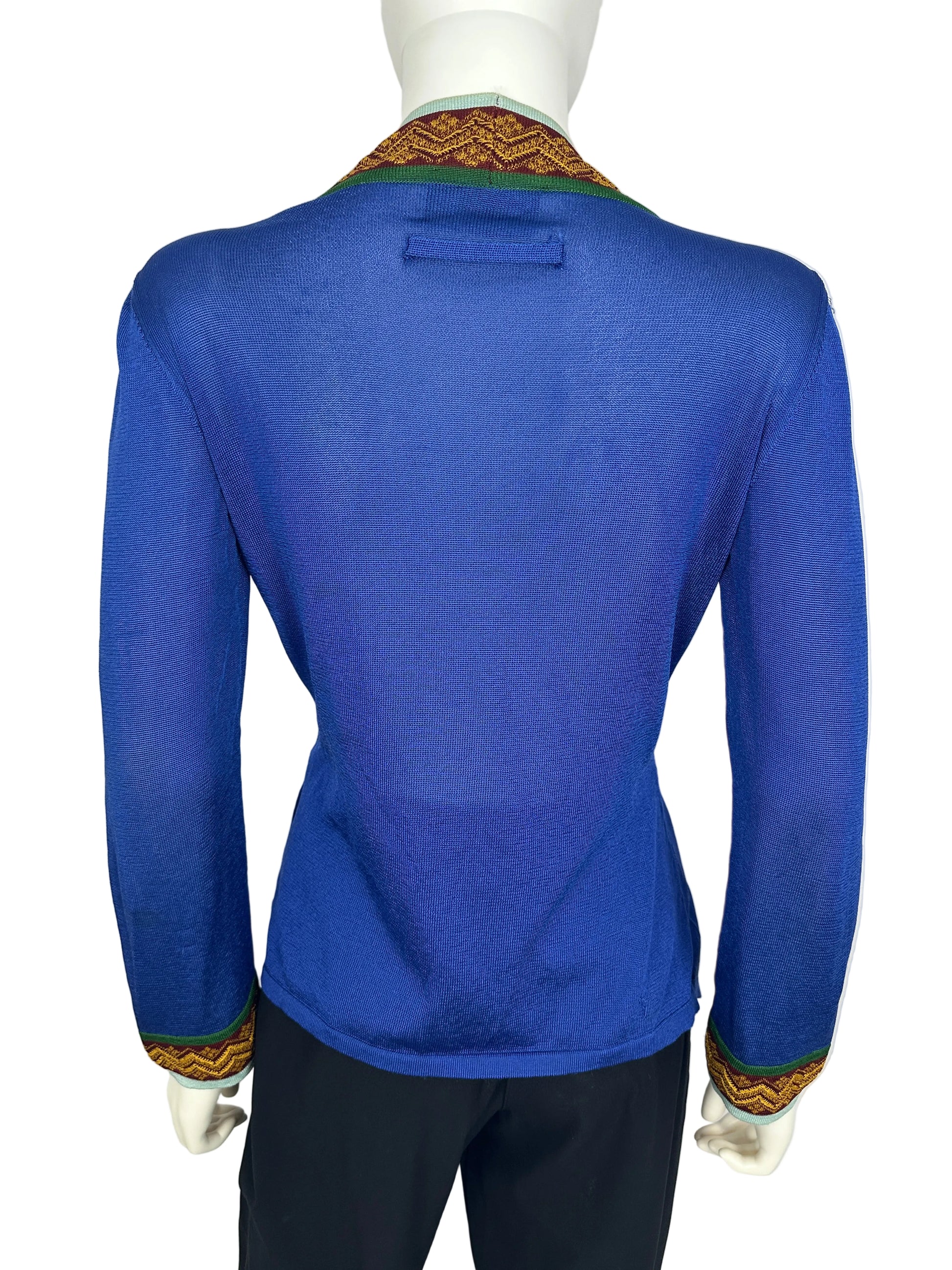 Blue cardigan with gold trim on a white background