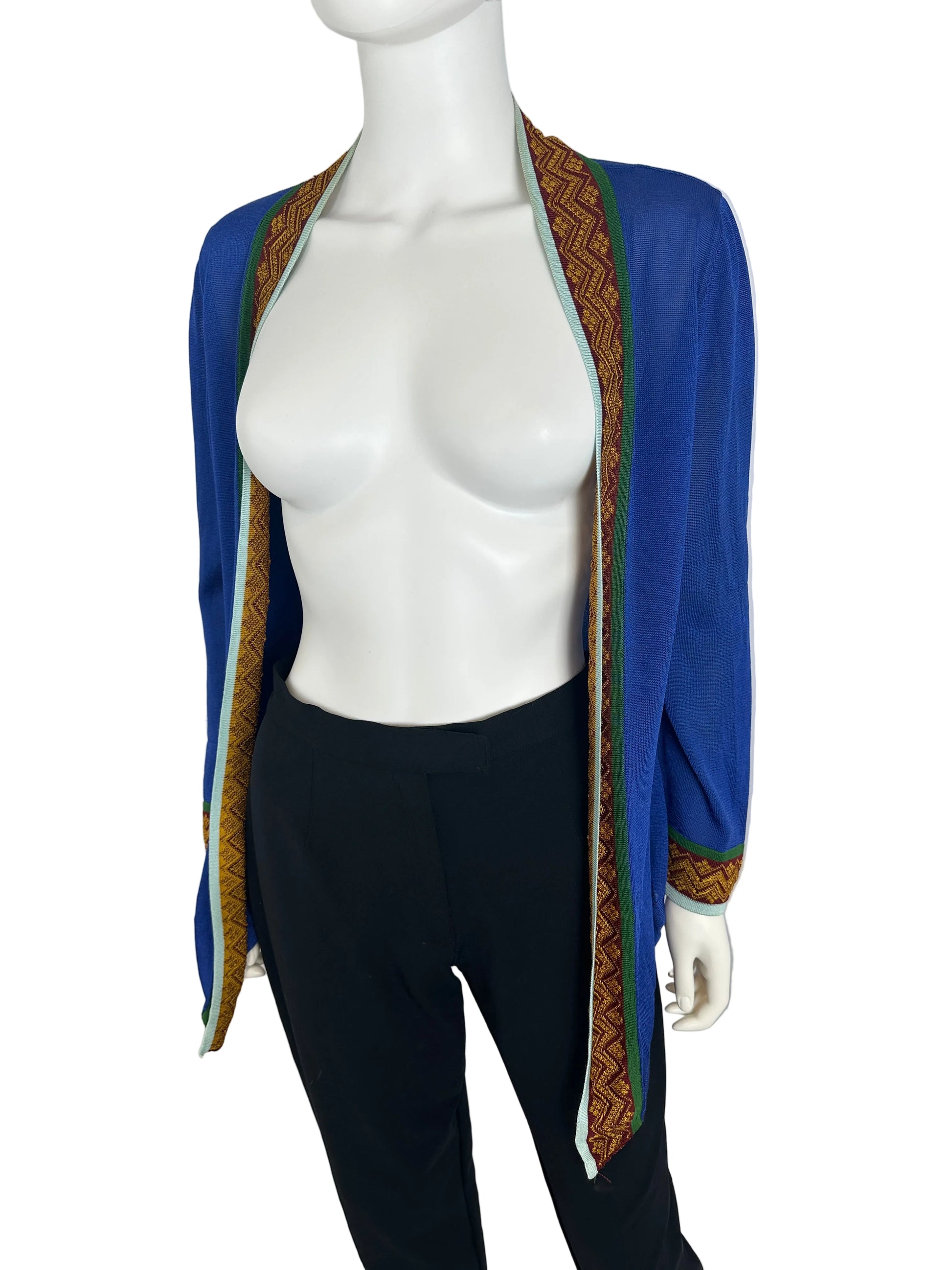 Mannequin wearing a blue cardigan against a gray background