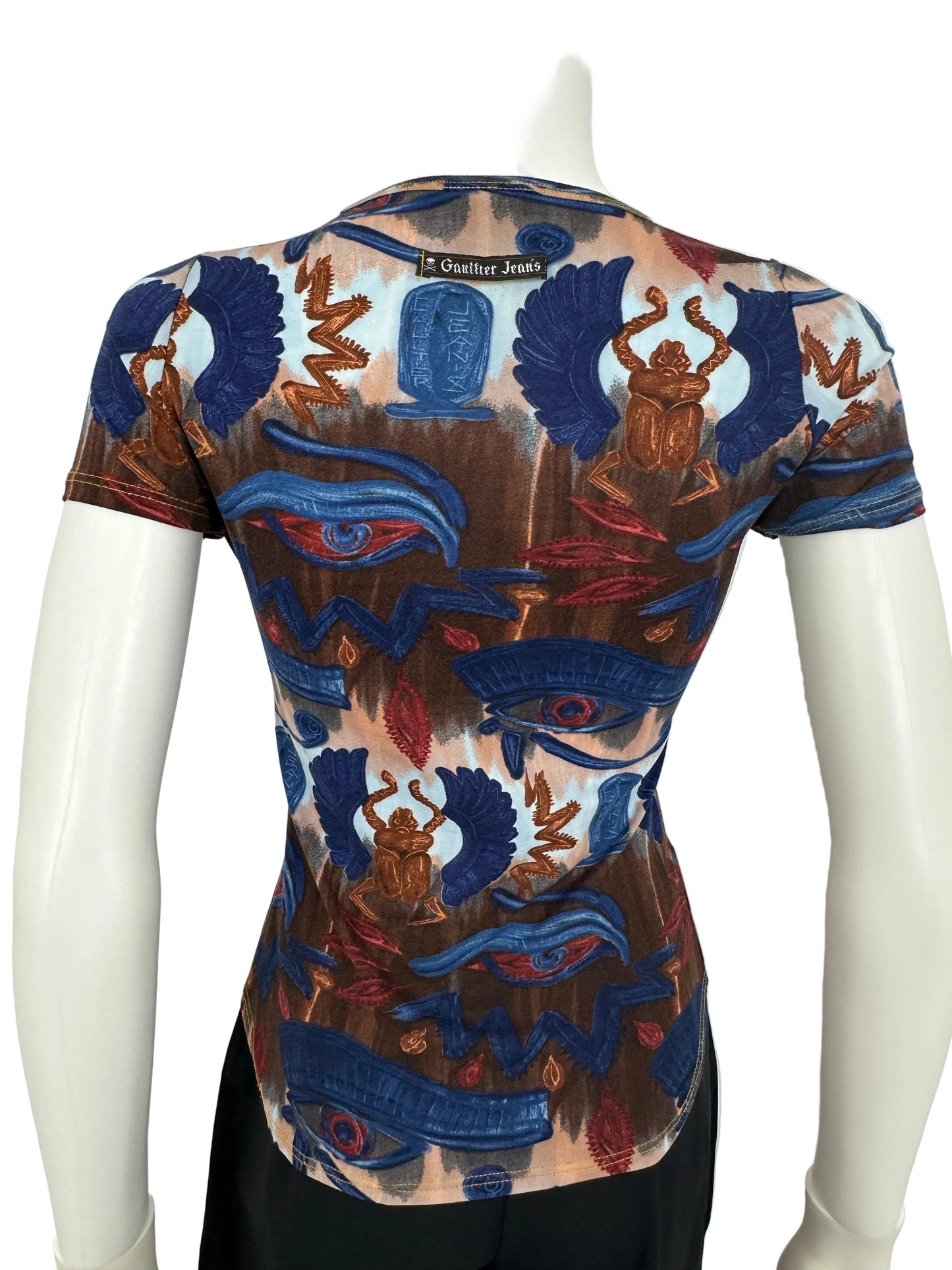 Colorful patterned top on a mannequin against a white background
