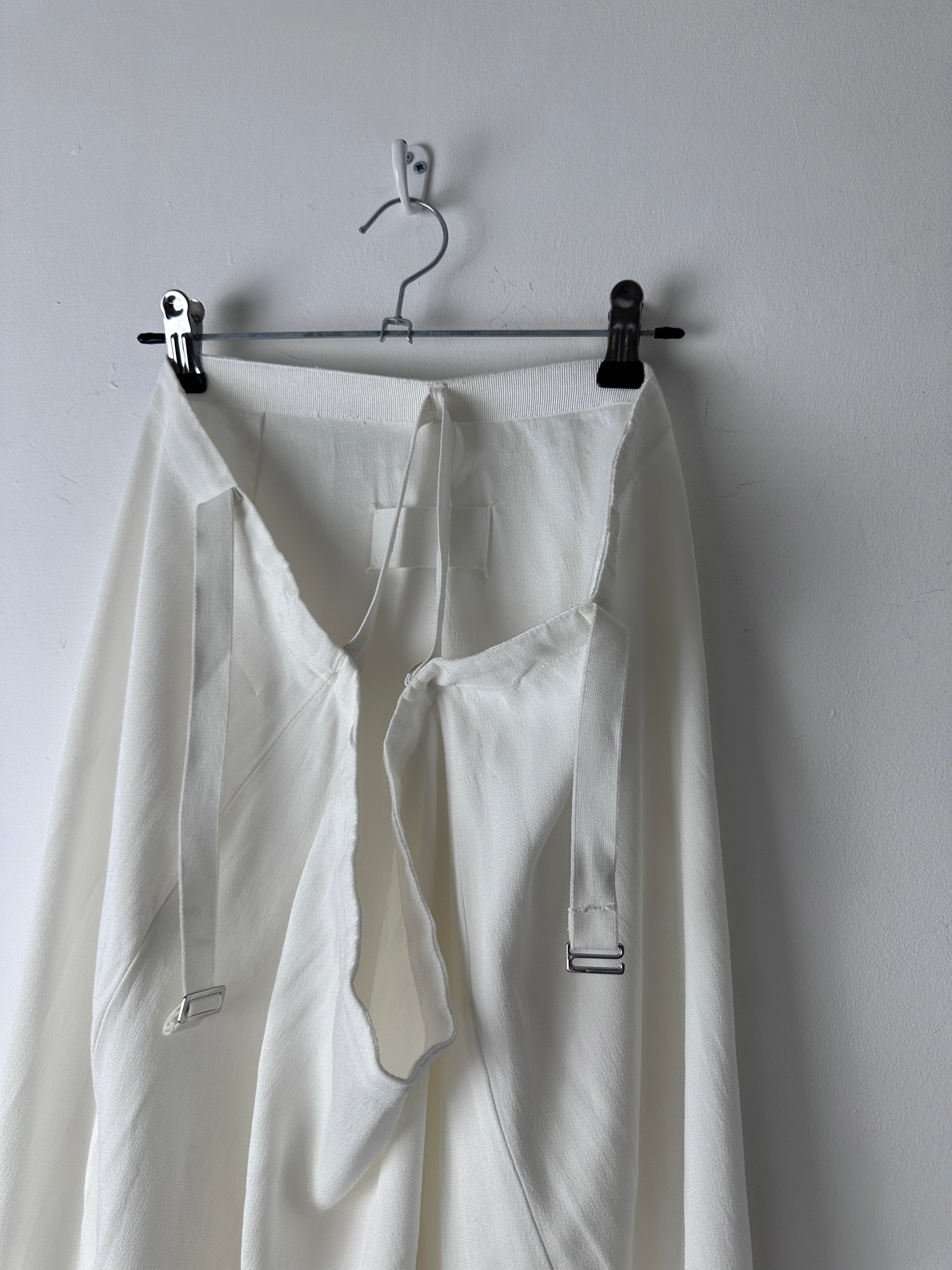 Close up of a white skirt on a hanger