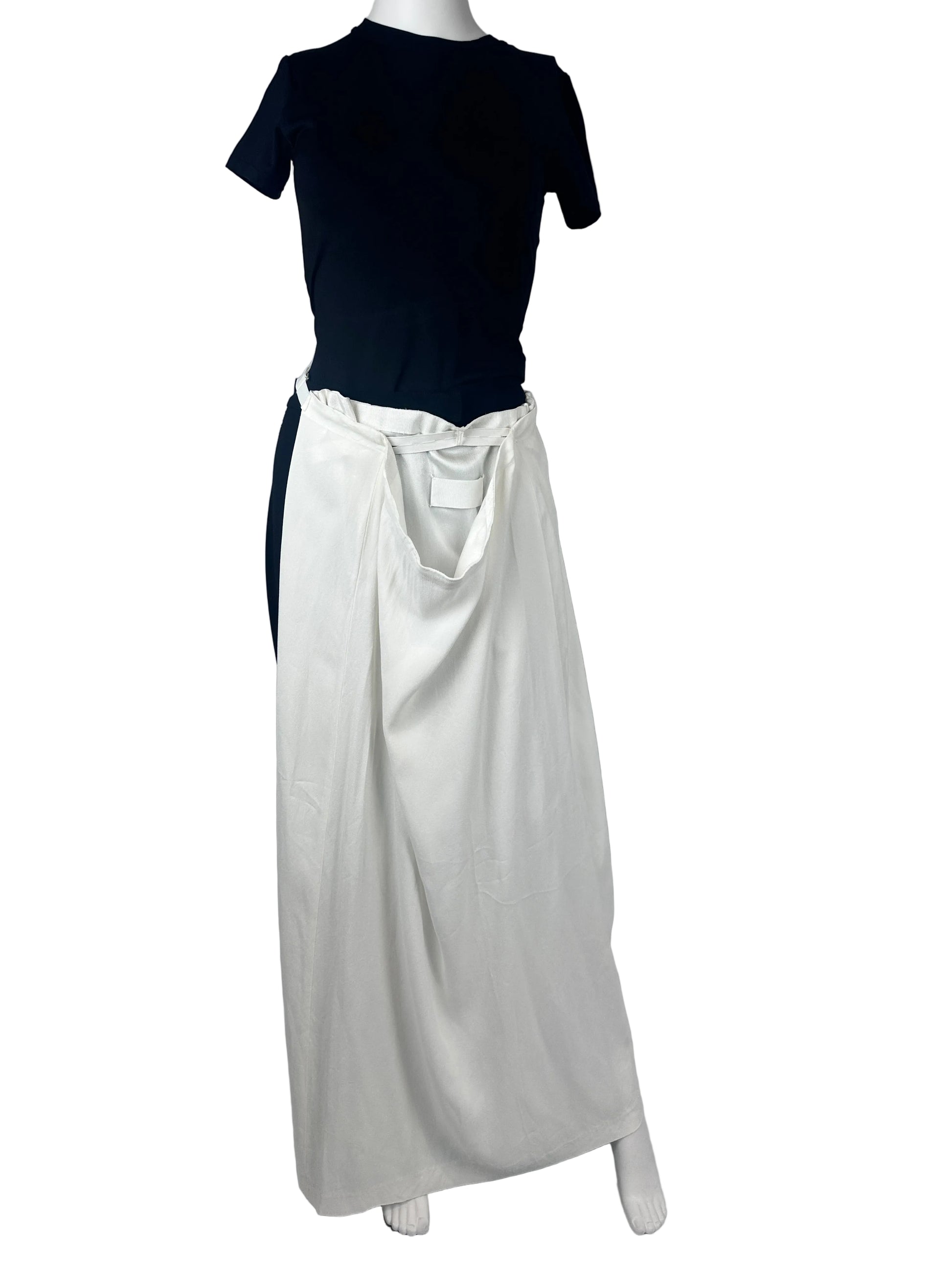White skirt worn as a belt on a mannequin in a black outfit