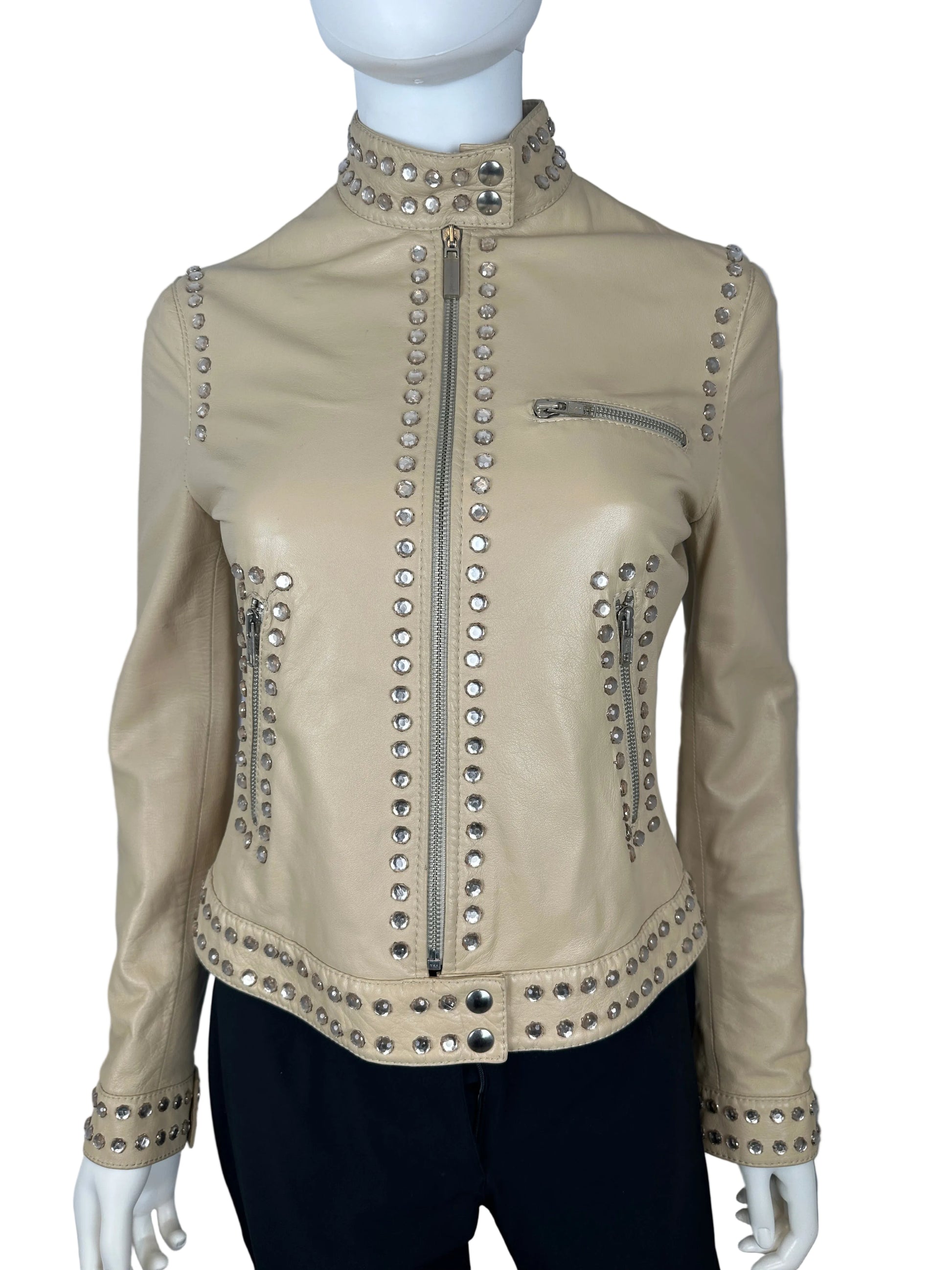Beige leather jacket with silver studs on a mannequin against a gray background