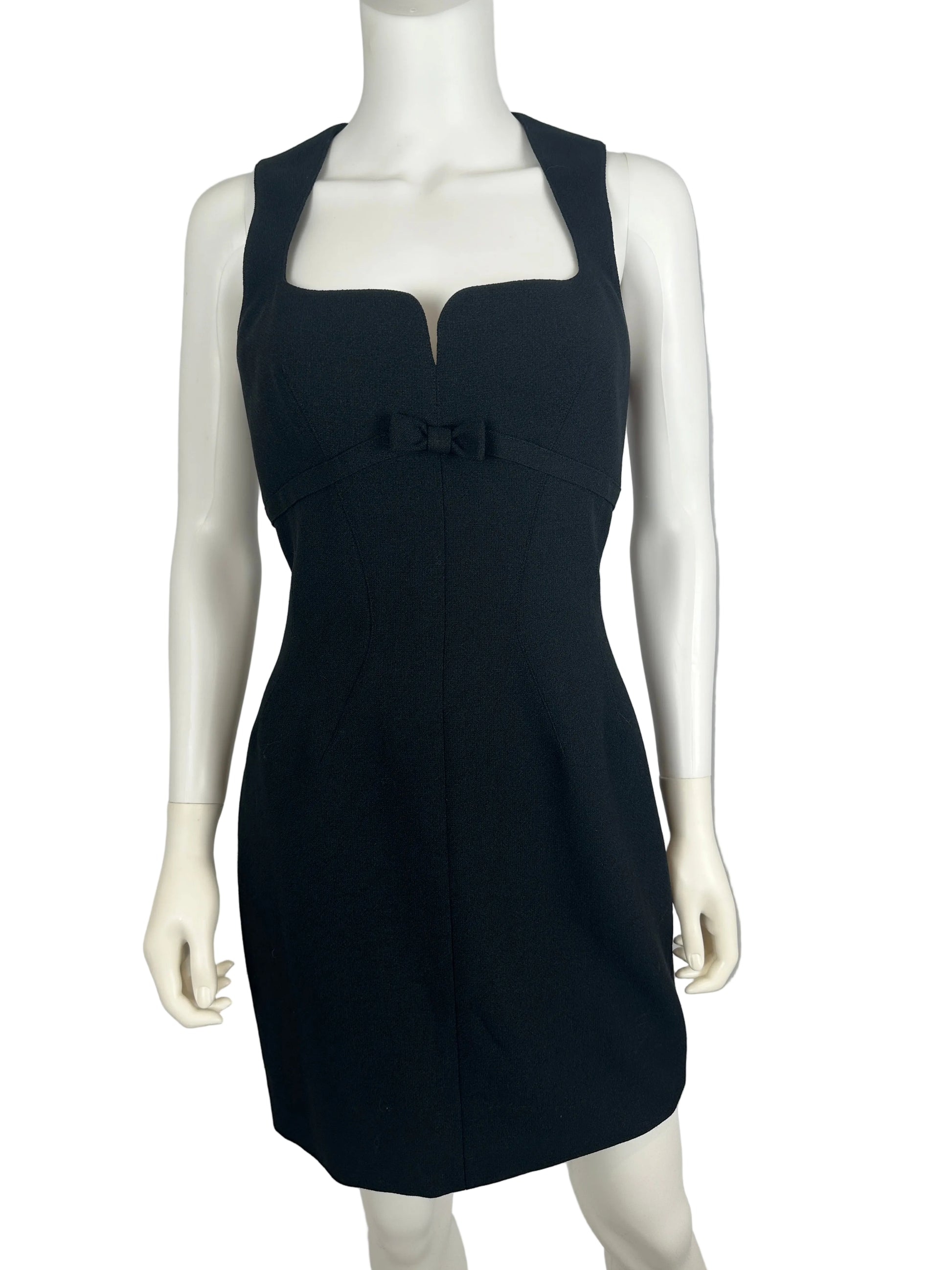 Black dress on a mannequin against a gray background