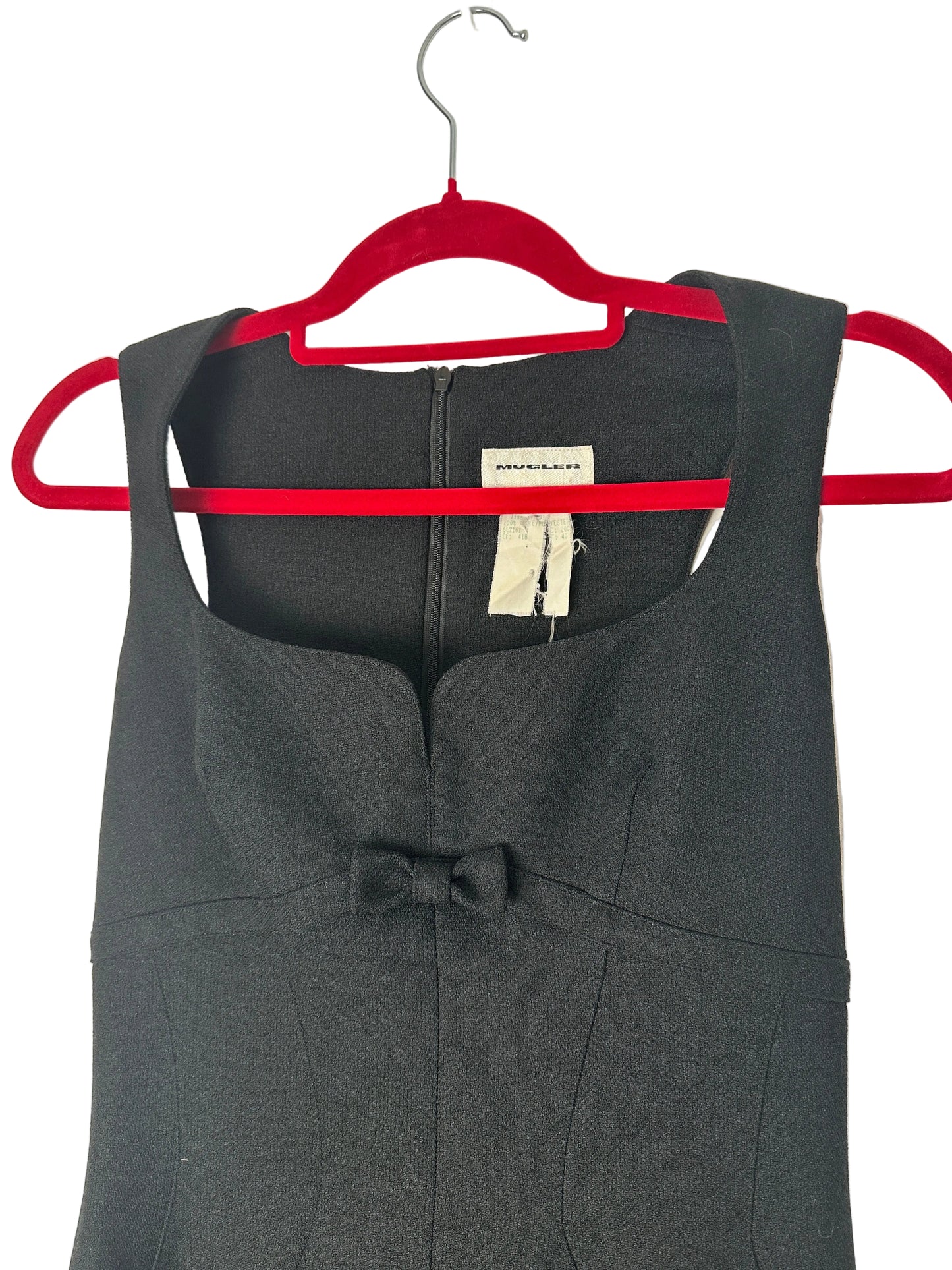Dress a red hanger against a beige background