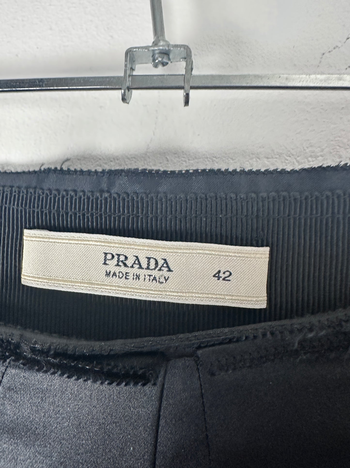 Close-up of a Prada label on a garment with a blurred background
