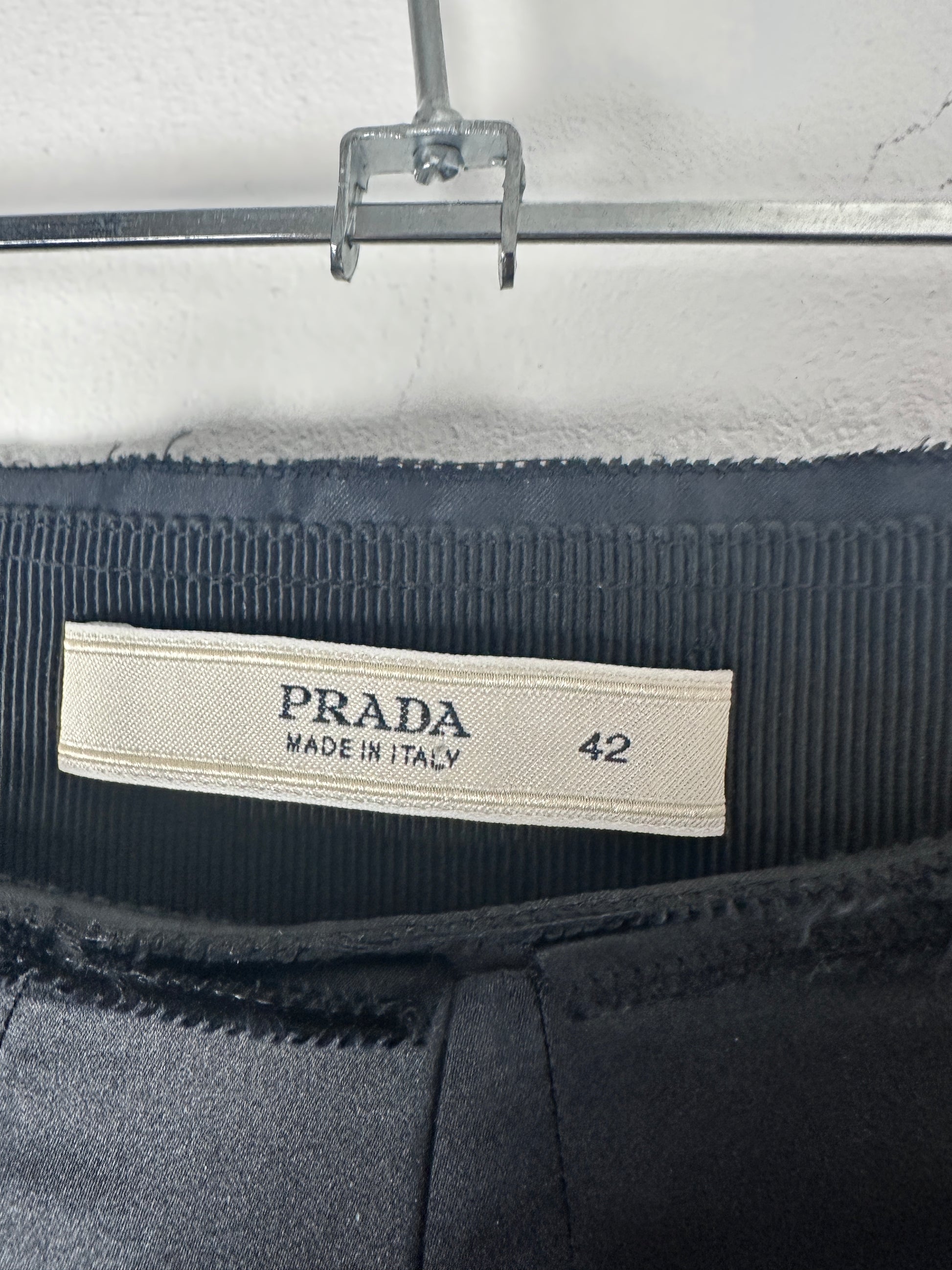 Close-up of a Prada label on a garment with a blurred background