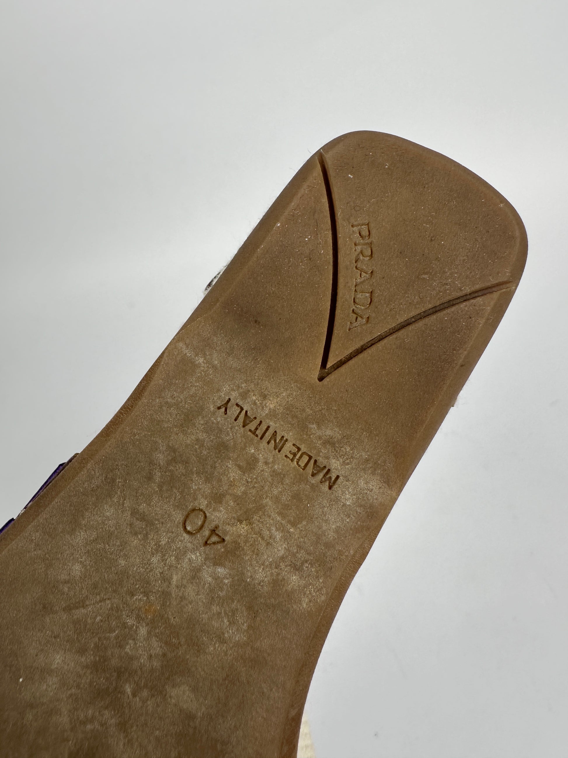 Close-up of a Prada shoe sole with brand name and size '40' on a light gray background