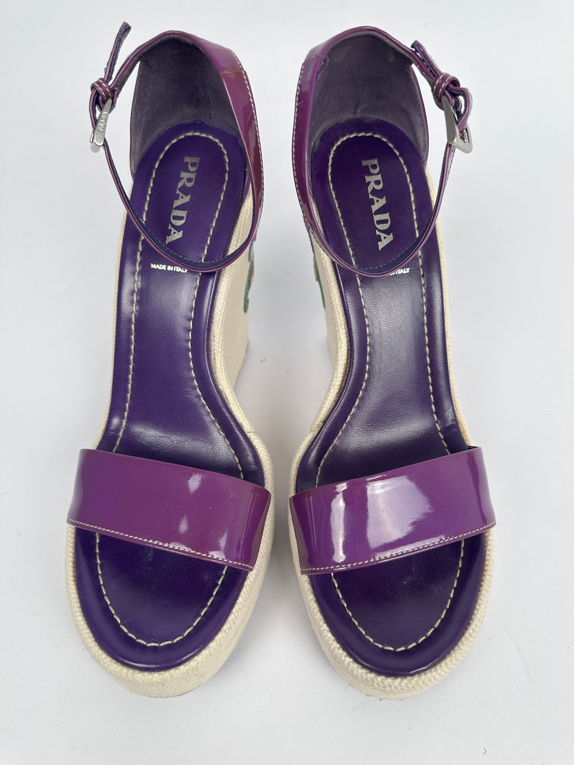 Purple Prada sandals on a white background