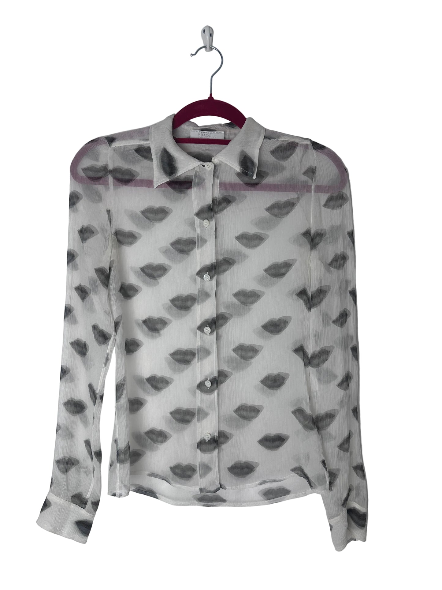 Lips print sheer top on a red hanger