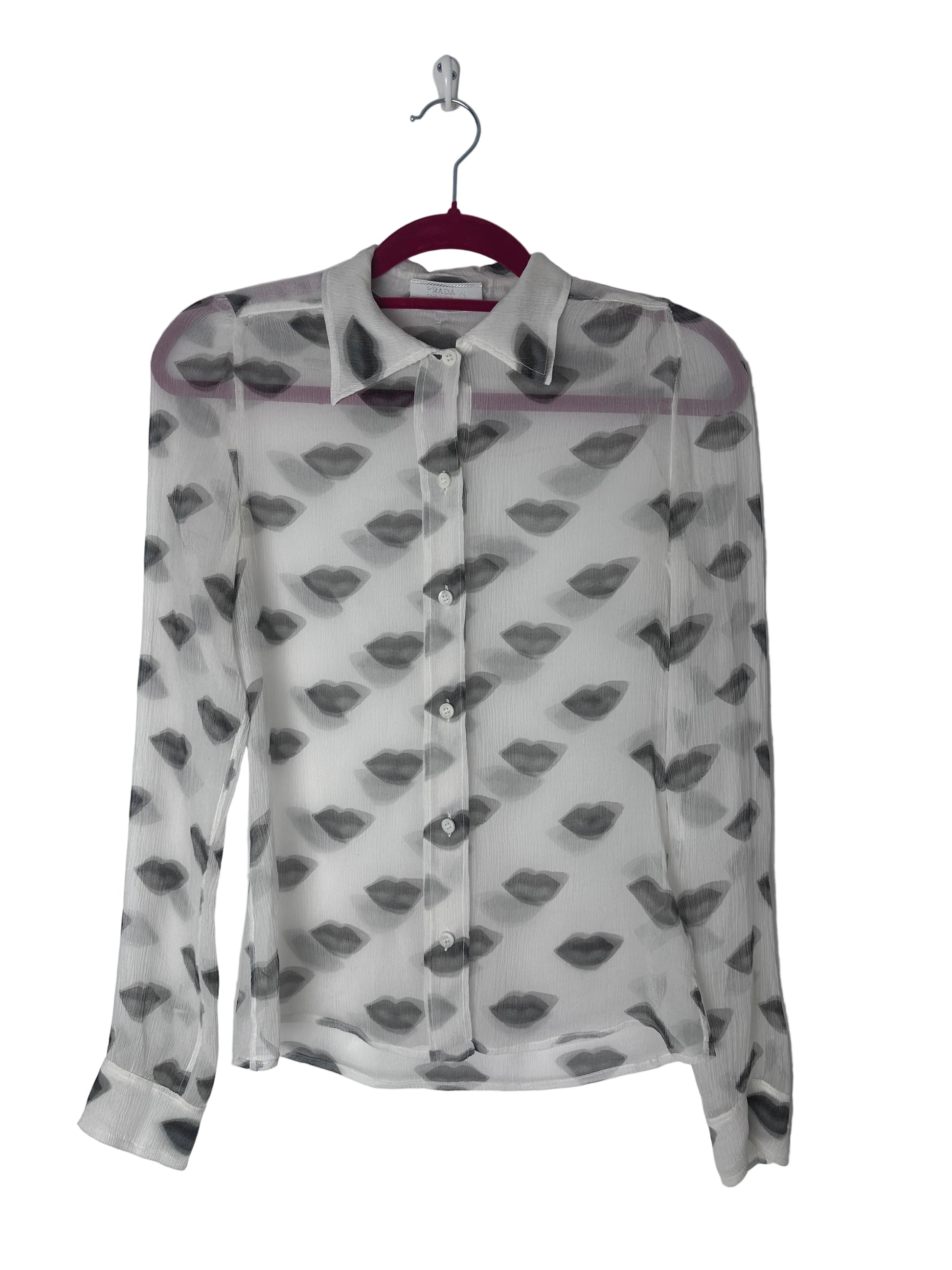 Lips print sheer top on a red hanger