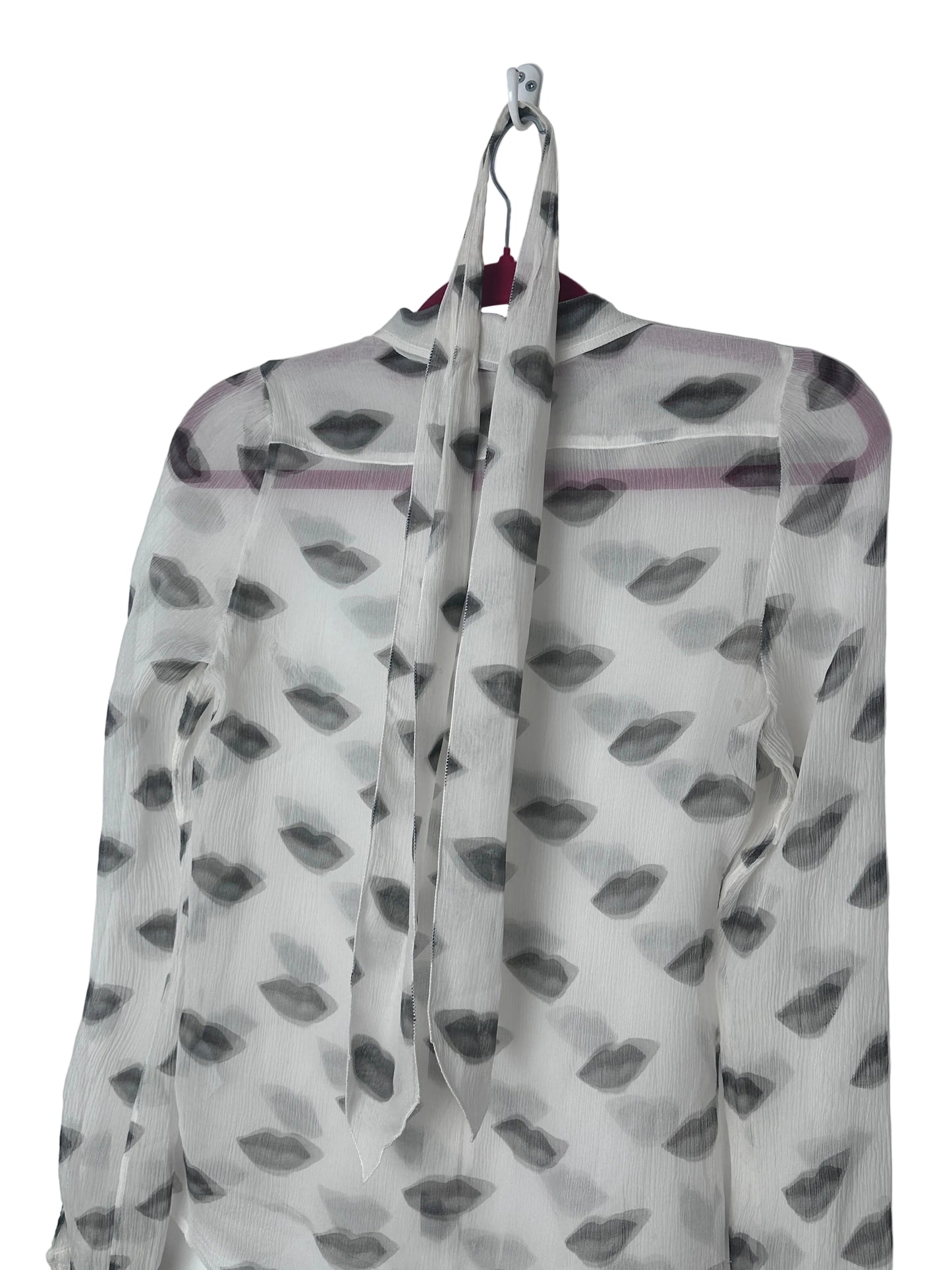 Lips print sheer shirt on a red hanger