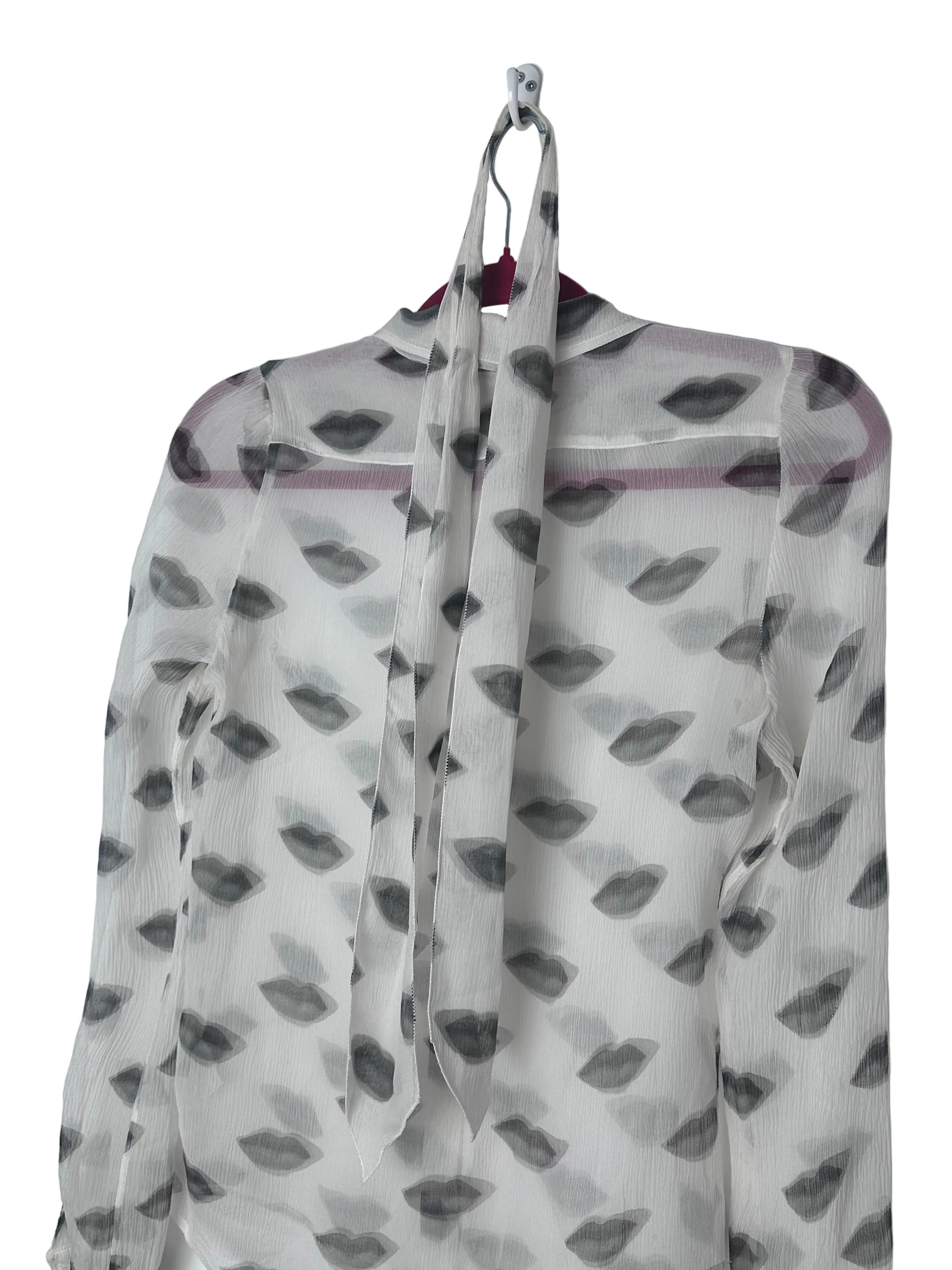 Lips print sheer shirt on a red hanger