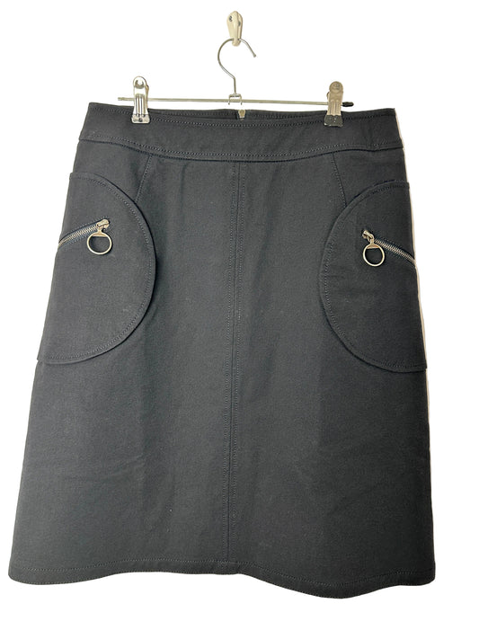 Black Skirt on a hanger against a beige background