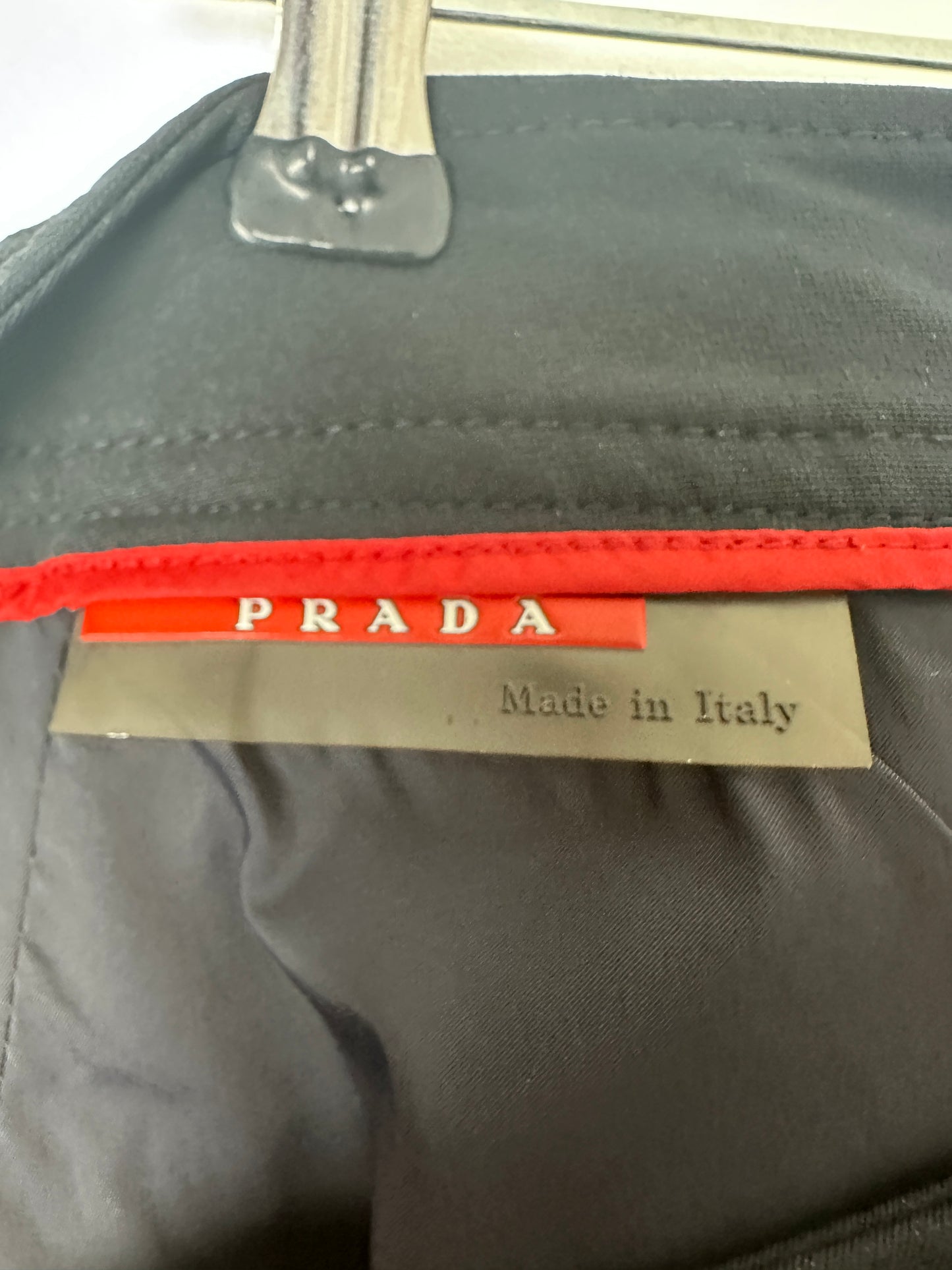 Gray bag with a Prada tag and 'Made in Italy' label.