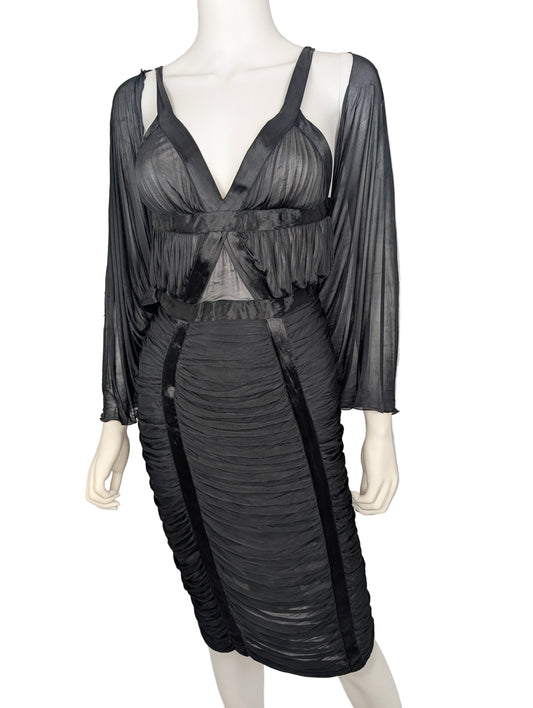 Black sheer dress on a mannequin against a white background