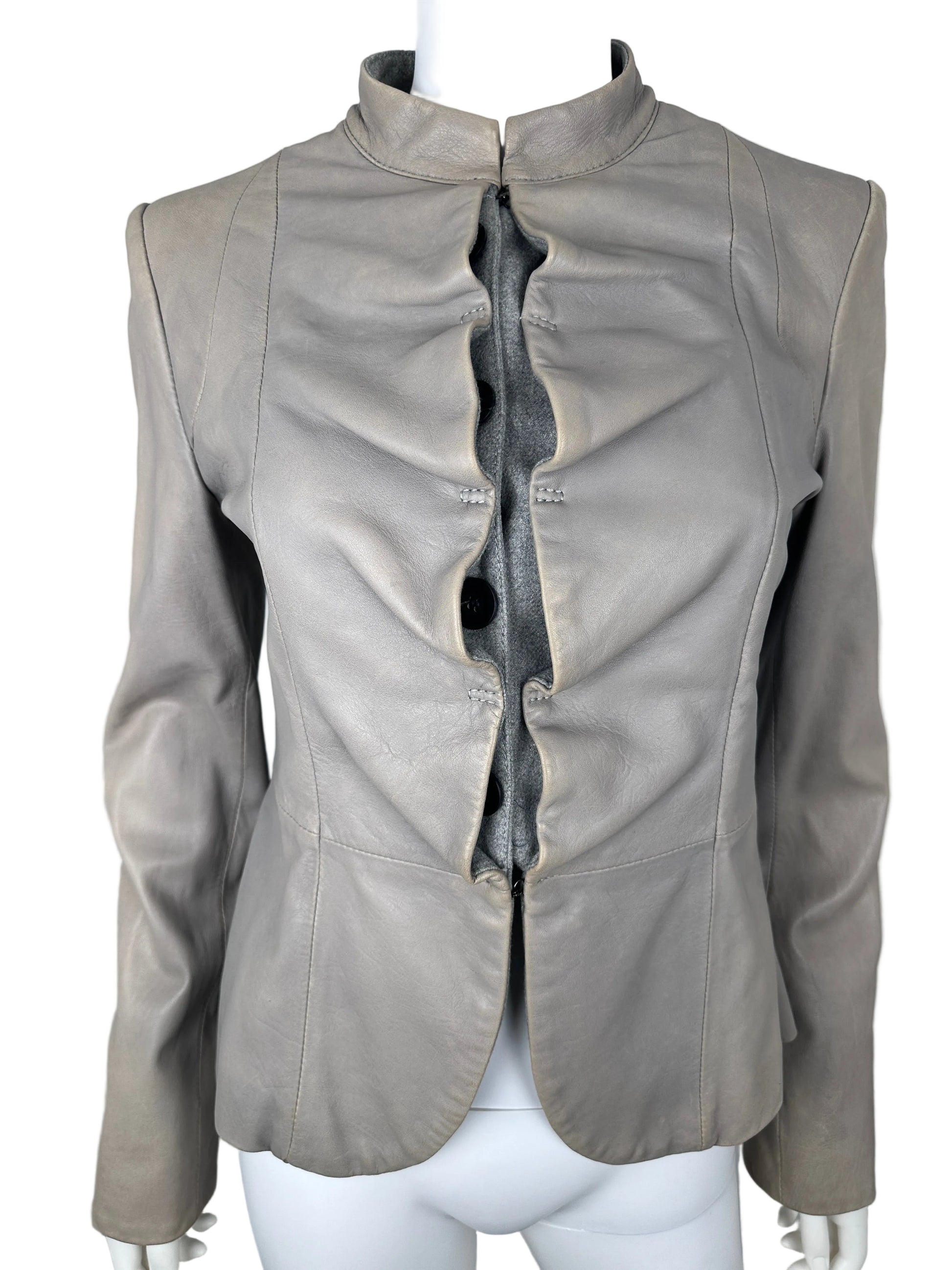 Gray leather jacket on a white stand against a light gray background