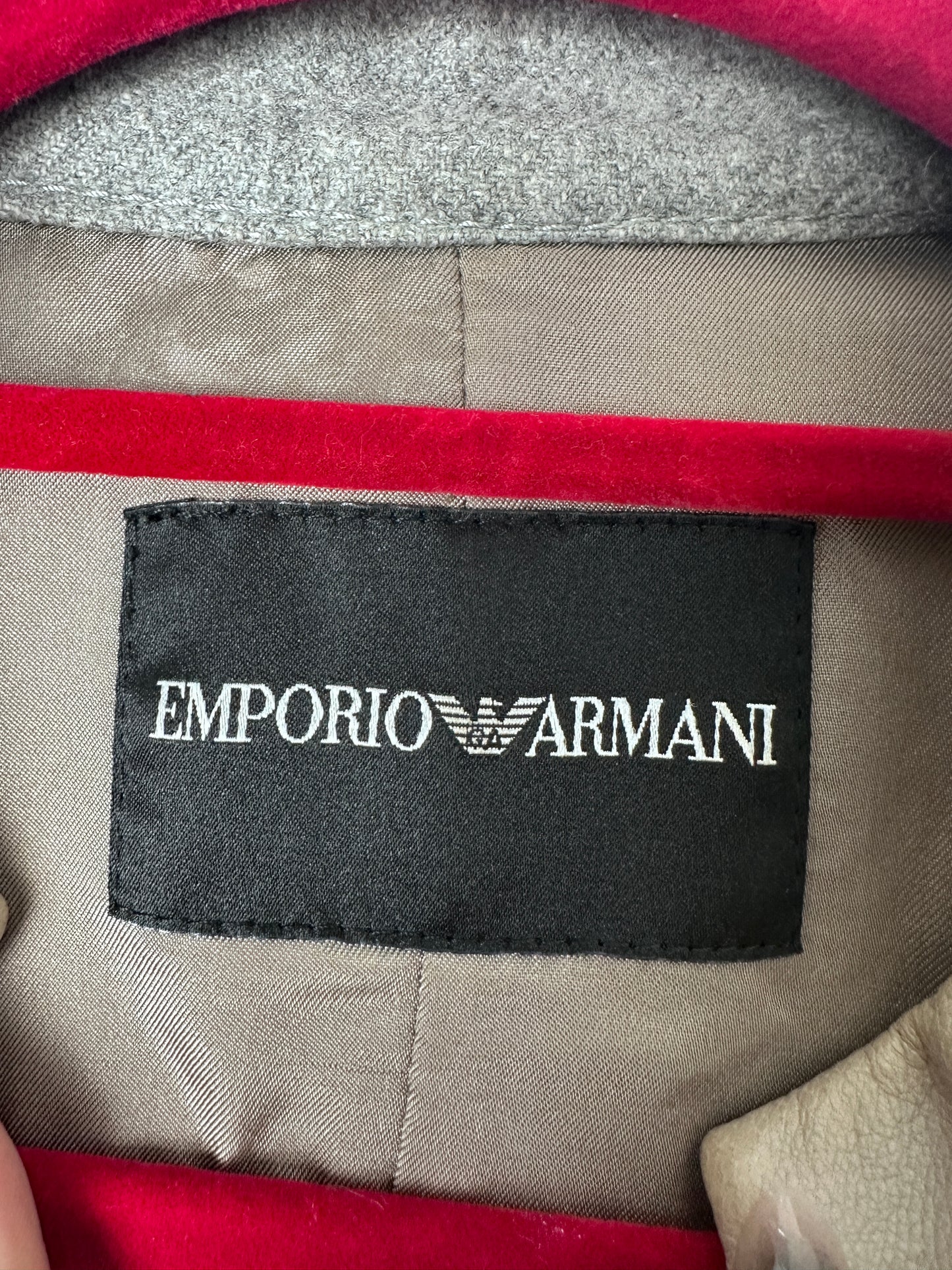 Emporio Armani label on a garment with red and gray details