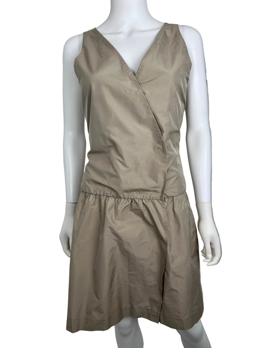 Mannequin wearing a beige dress against a plain background