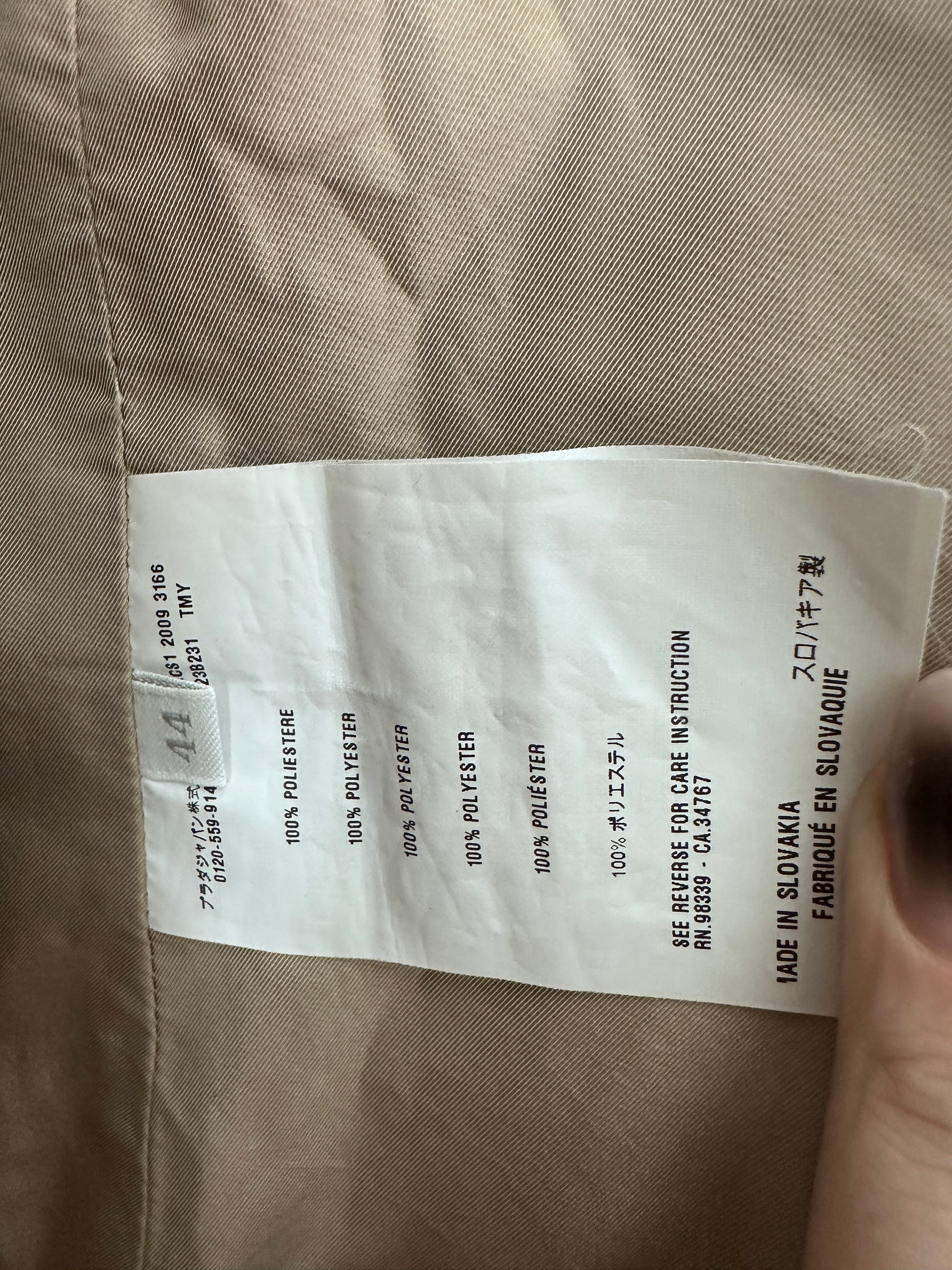 Text label on a beige fabric background